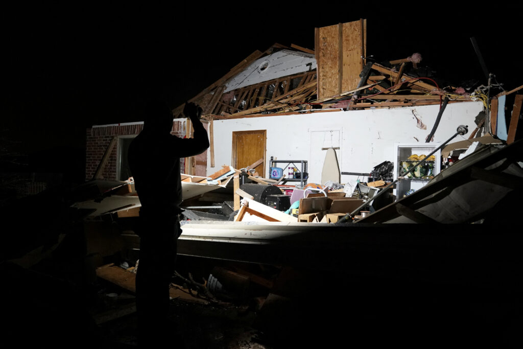 Chandler Browning looks over his in-laws home that was destroyed by a tornado after a tornado in Norman, Oklahoma, U.S. February 27, 2023. REUTERS/Nick Oxford
