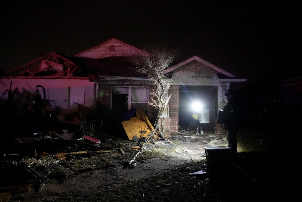 Residents work to recover items from a home that was hit by a tornado in Norman, Oklahoma, U.S. February 27, 2023. REUTERS/Nick Oxford