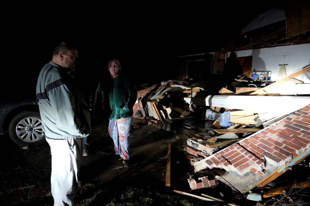 Stephen Buckner, left, and his wife Barbara Buckner look over their home that was destroyed by a tornado in Norman, Oklahoma, U.S. February 27, 2023. REUTERS/Nick Oxford