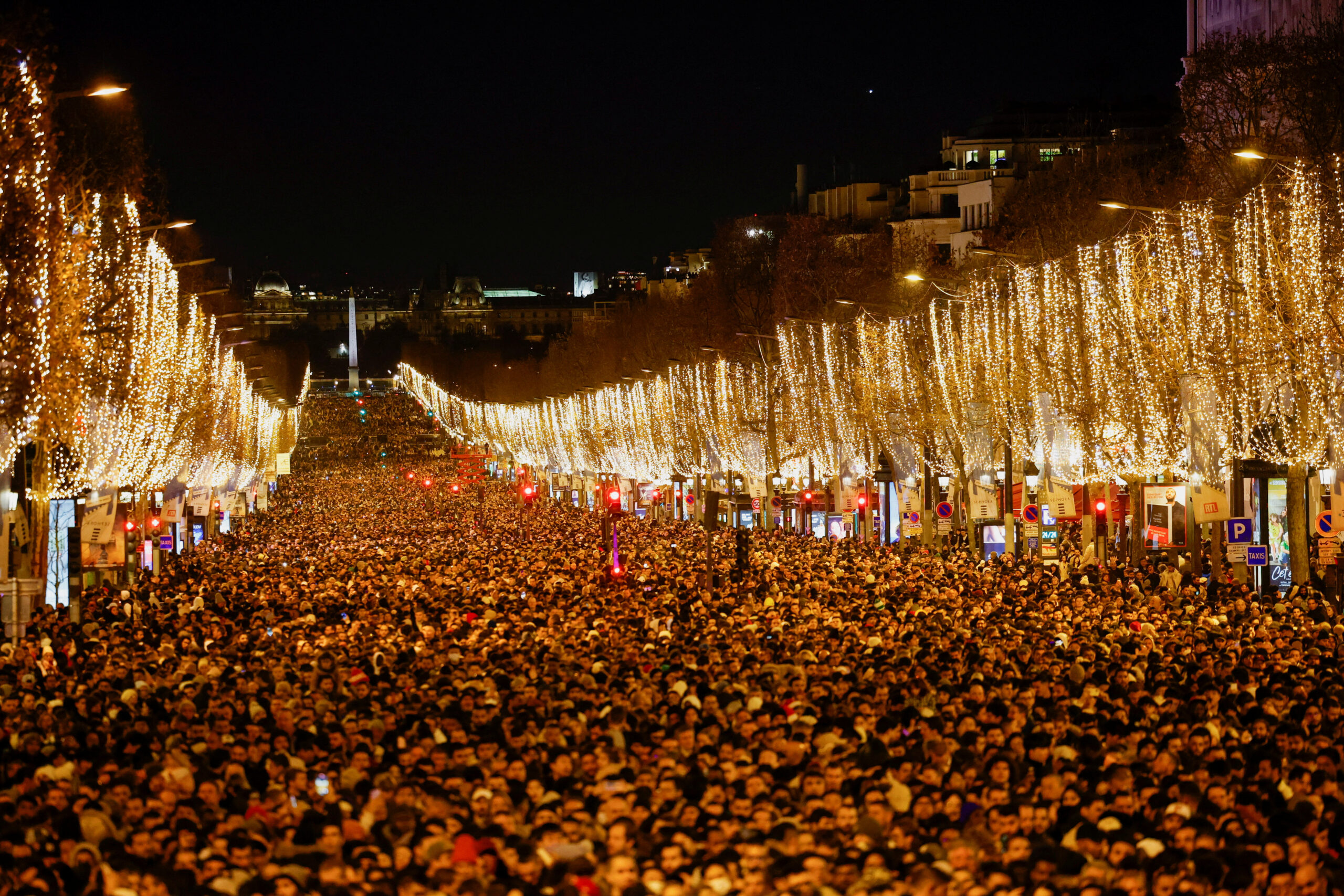 People gather on the Champs Elysees avenue during the New Year's Eve celebrations near the Arc de Triomphe in Paris, France, December 31, 2022. REUTERS/Sarah Meyssonnier