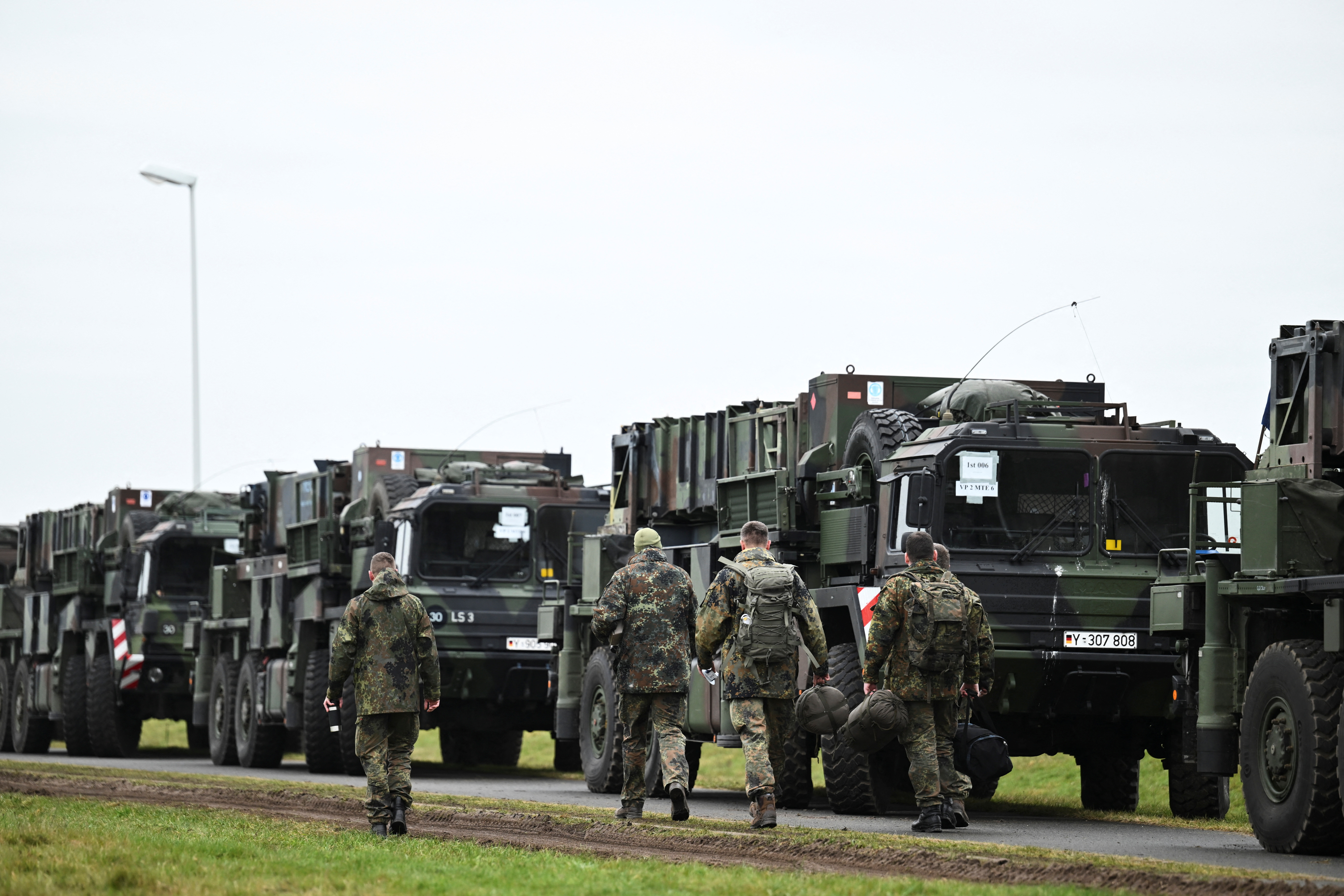 German Air Force soldiers walk near the convoy vehicles, as the mobile defence surface-to-air missile systems, Patriots, are transported to Poland from Gnoien, Germany, January 23, 2023. REUTERS/Annegret Hilse