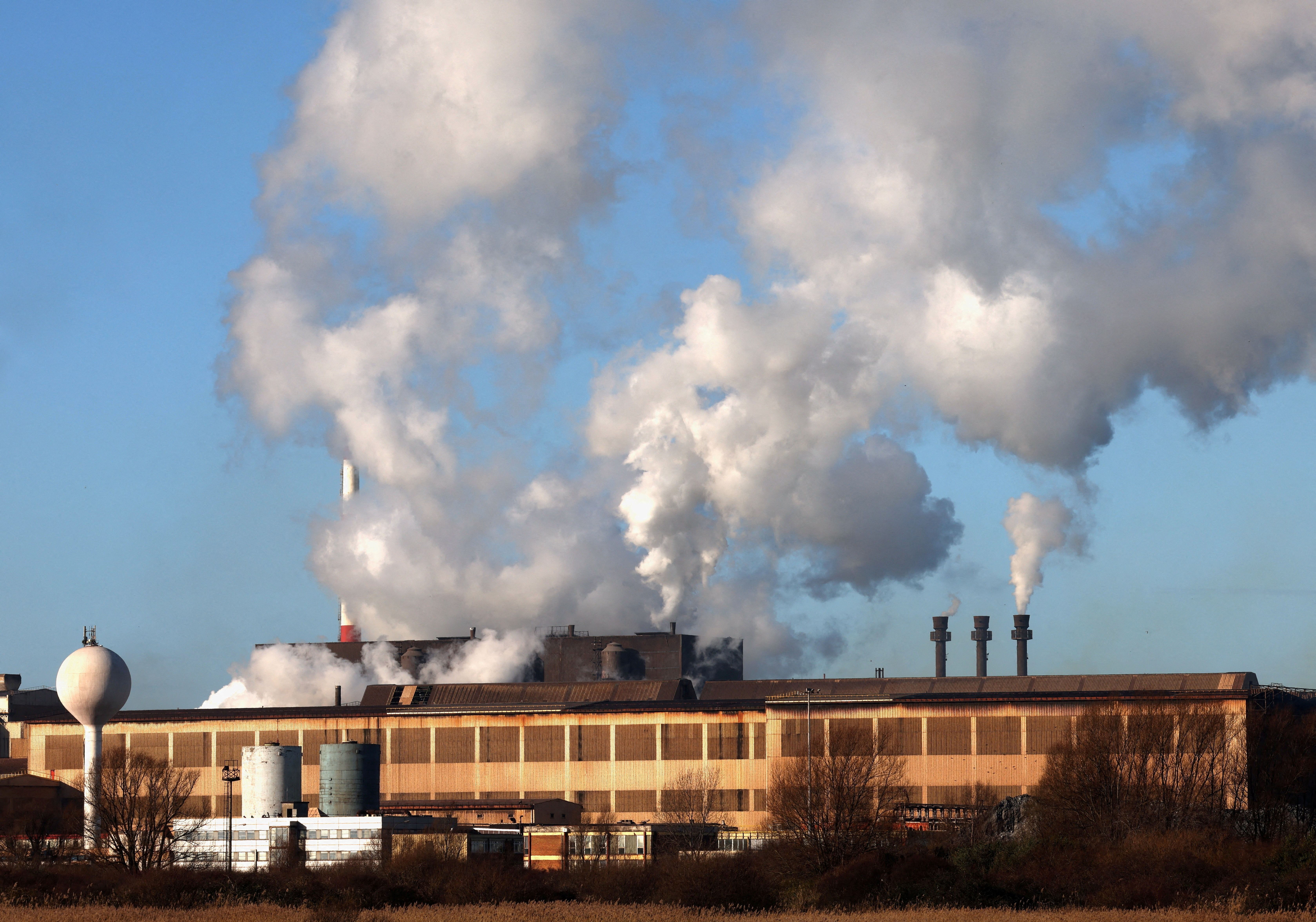 FILE PHOTO: Smoke rises from chimneys at a factory in the port of Dunkirk, France  January 19, 2023. REUTERS/Yves Herman/File Photo