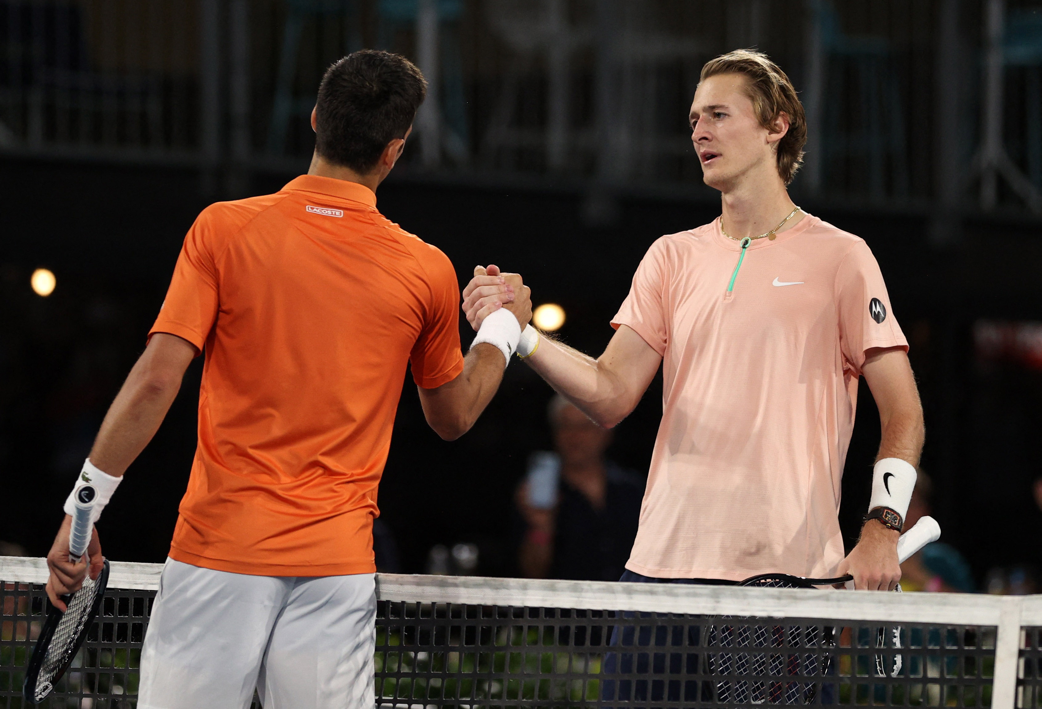 Tennis - Adelaide International - Memorial Drive Tennis Club, Adelaide, Australia - January 8, 2023 Serbia's Novak Djokovic with Sebastian Korda of the U.S. after winning his match in the final REUTERS/Loren Elliott