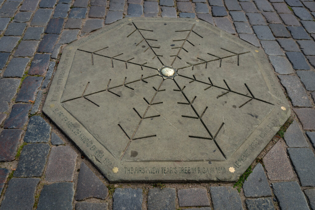 Riga, Latvia - August 11 2017: A plaque commerating the site of the first Christmas tree in 1510 in Ratslaukums, in Riga (Latvia).
