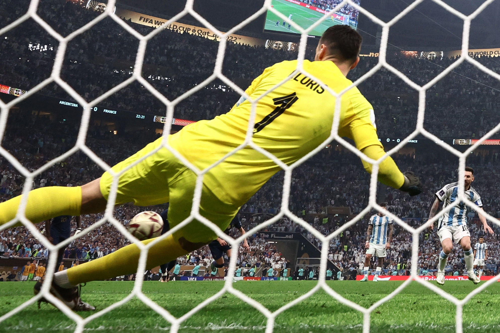 Soccer Football - FIFA World Cup Qatar 2022 - Final - Argentina v France - Lusail Stadium, Lusail, Qatar - December 18, 2022  Argentina's Lionel Messi scores their first goal from the penalty spot past France's Hugo Lloris REUTERS/Dylan Martinez