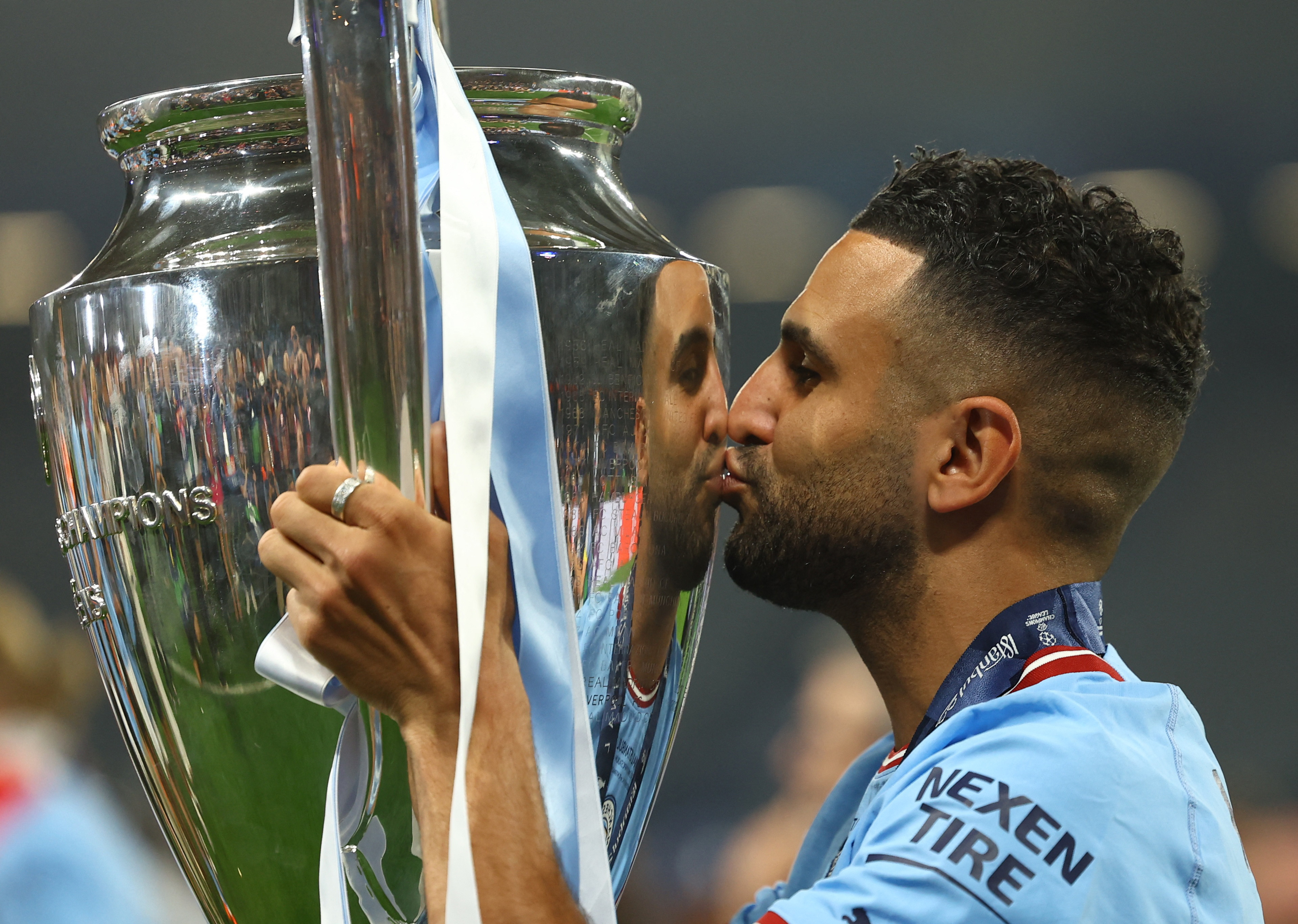 Soccer Football - Champions League Final - Manchester City v Inter Milan - Ataturk Olympic Stadium, Istanbul, Turkey - June 11, 2023 Manchester City's Riyad Mahrez celebrates with the trophy after winning the Champions League REUTERS/Molly Darlington