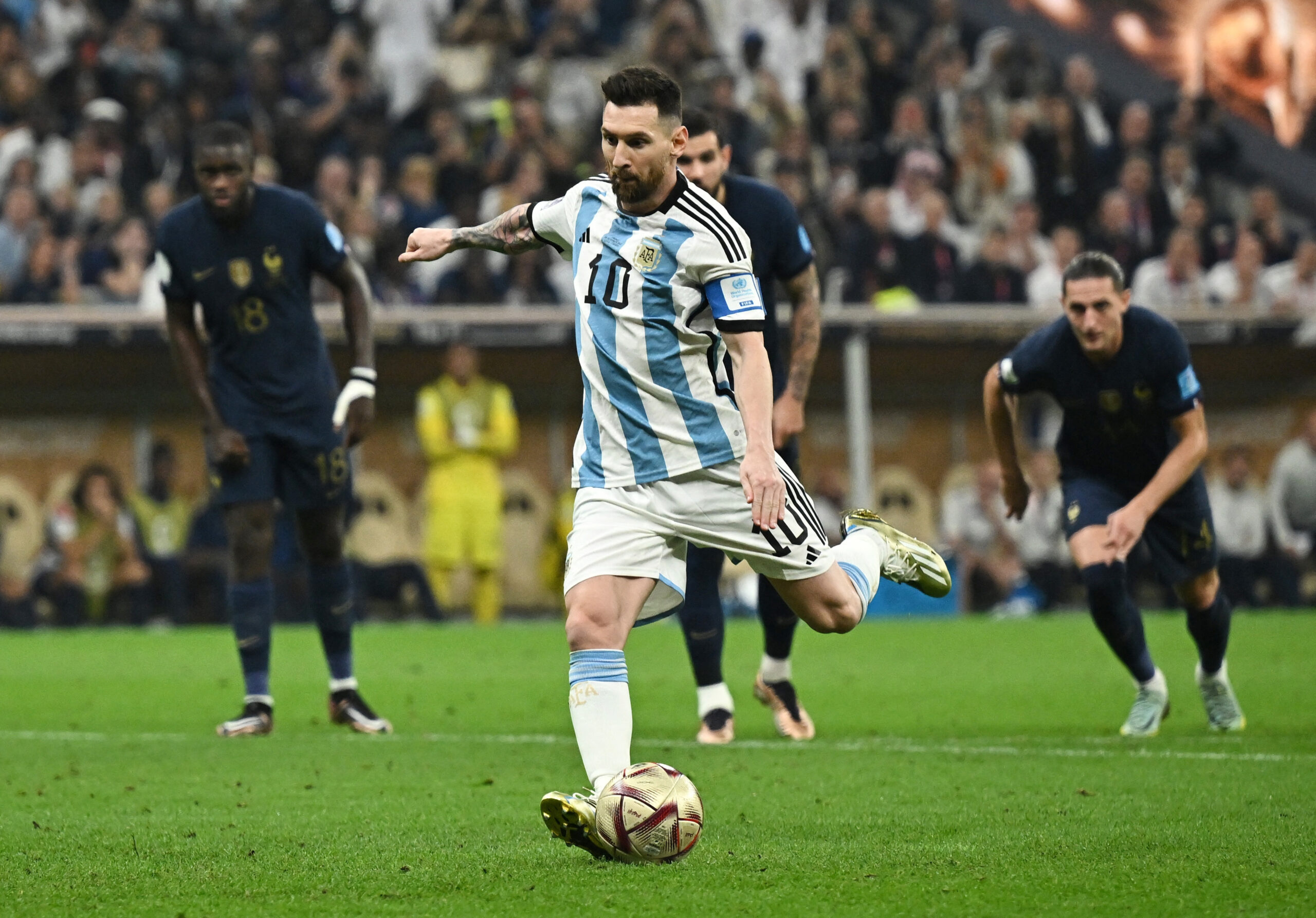 Soccer Football - FIFA World Cup Qatar 2022 - Final - Argentina v France - Lusail Stadium, Lusail, Qatar - December 18, 2022  Argentina's Lionel Messi scores their first goal from the penalty spot REUTERS/Dylan Martinez