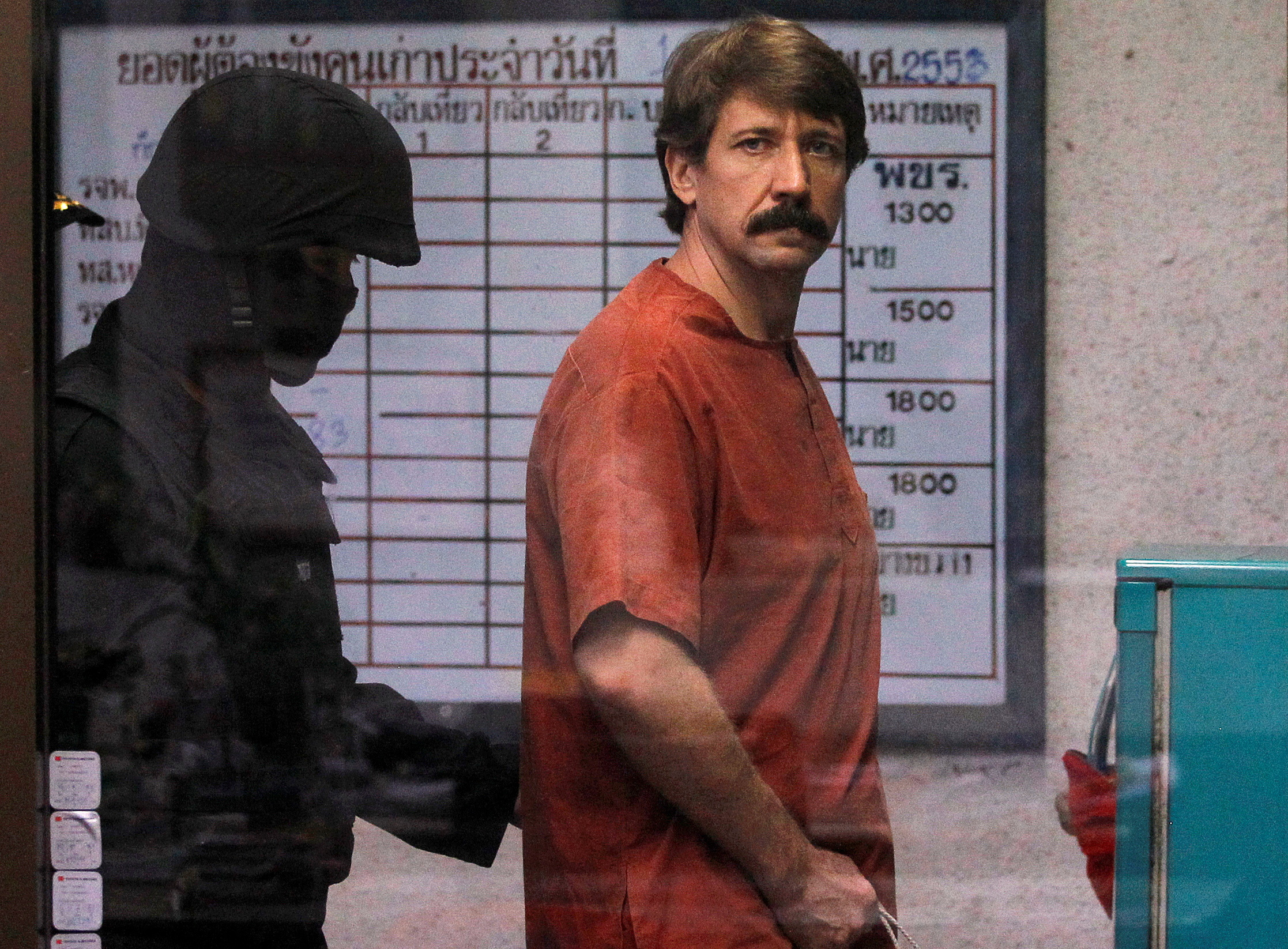 FILE PHOTO: Alleged arms smuggler Viktor Bout from Russia is escorted by a member of the special police unit as he arrives at a criminal court in Bangkok October 4, 2010. REUTERS/Damir Sagolj/File Photo