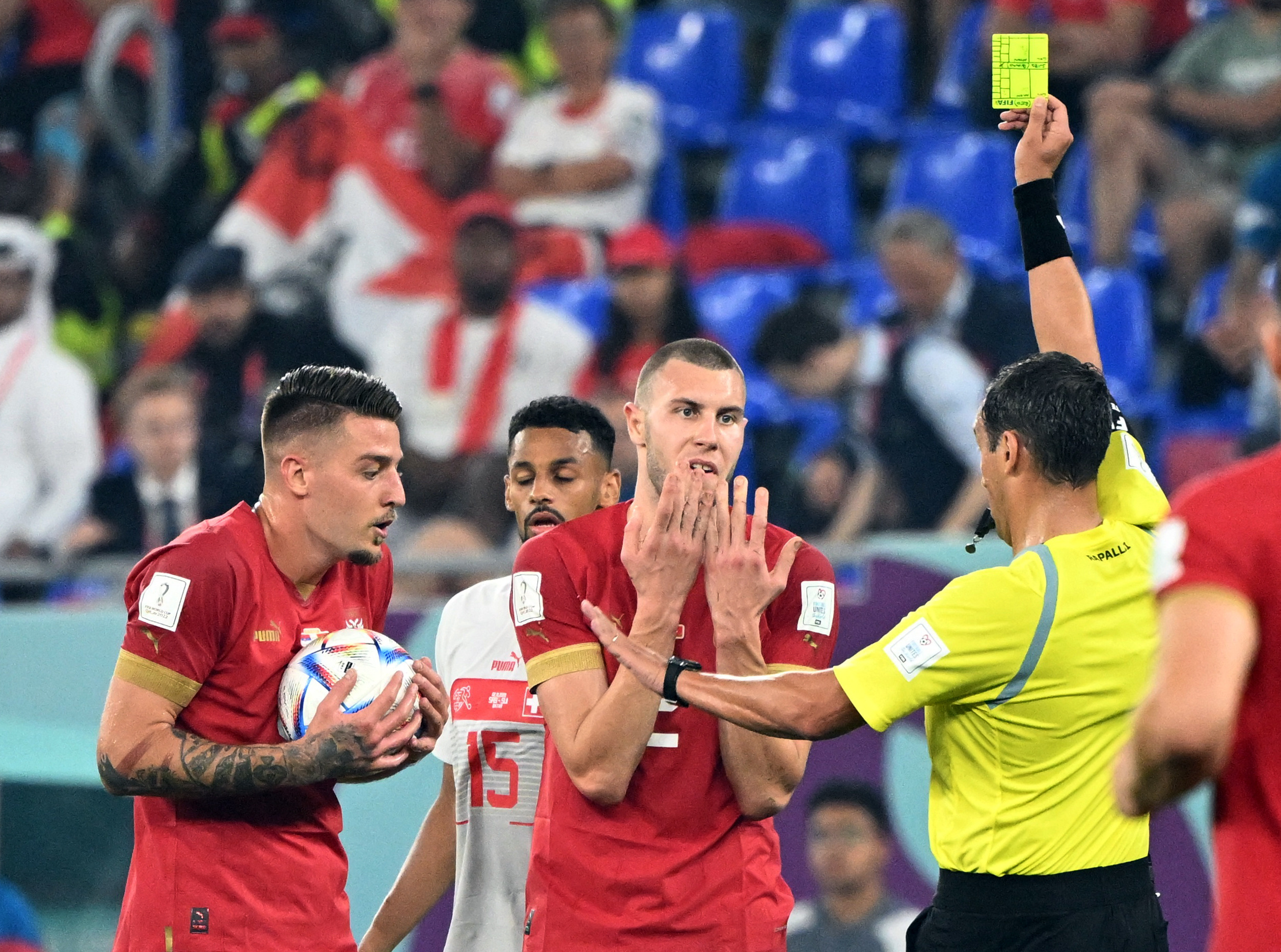 Soccer Football - FIFA World Cup Qatar 2022 - Group G - Serbia v Switzerland - Stadium 974, Doha, Qatar - December 2, 2022 Serbia's Strahinja Pavlovic is shown a yellow card by referee Fernando Rapallini REUTERS/Alberto Lingria