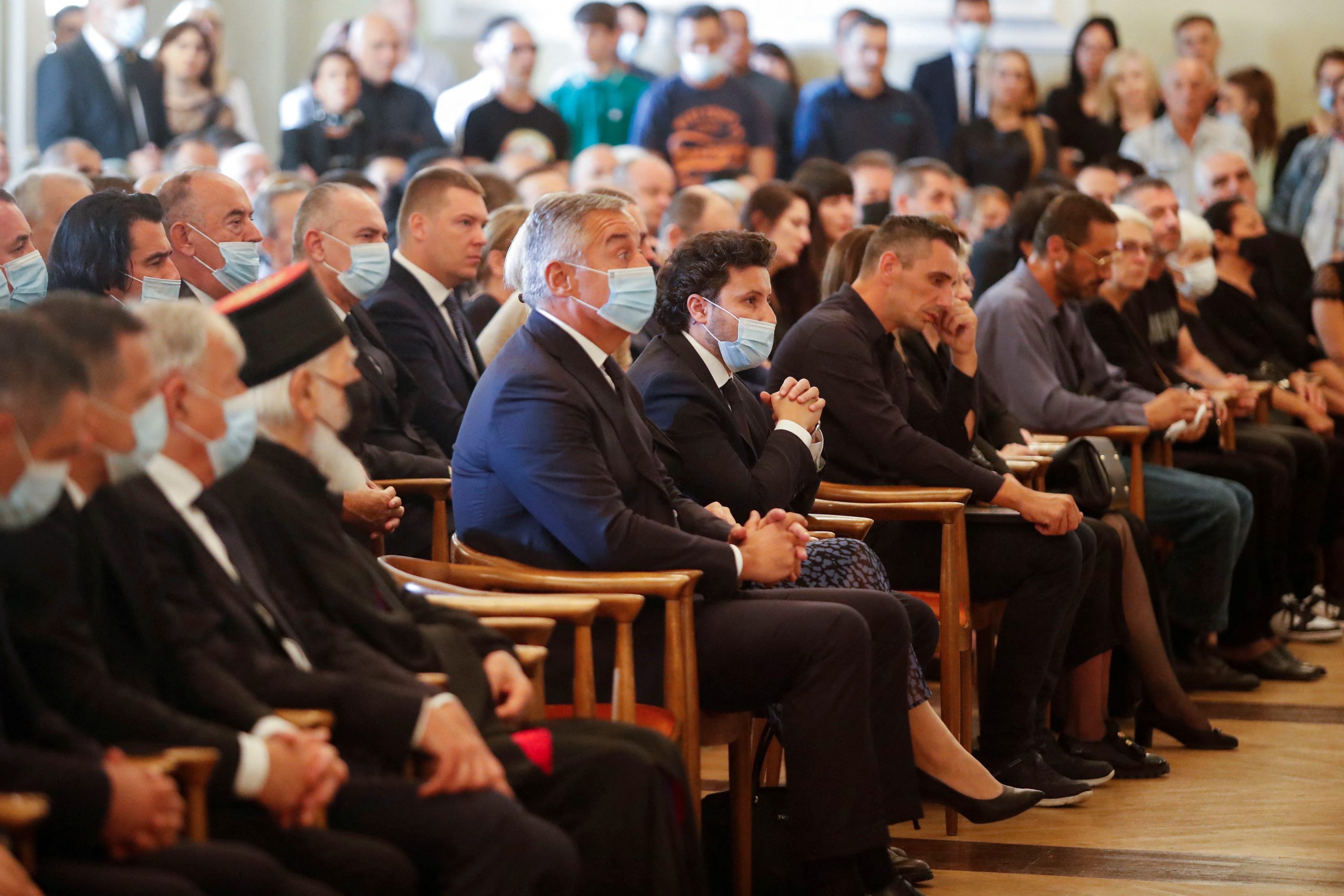 Montenegro's President Milo Djukanovic sits next to Prime Minister Dritan Abazovic during a commemoration ceremony for victims of a mass shooting in Cetinje, Montenegro August 14, 2022. REUTERS/Stevo Vasiljevic