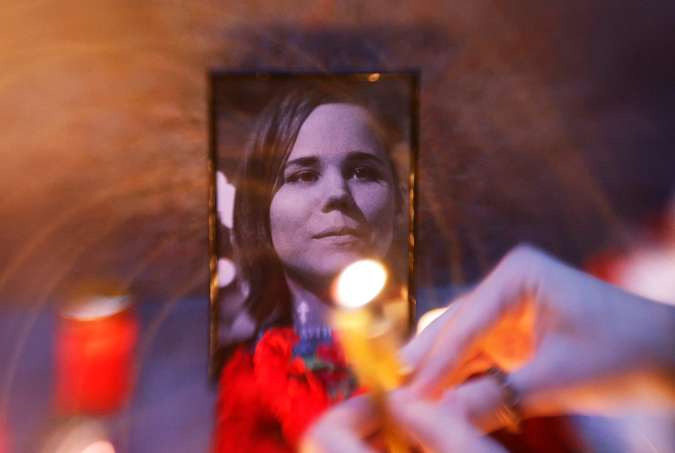 Flowers and candles are placed next to a portrait of media commentator Darya Dugina, who was killed in a car bomb attack, in Moscow, Russia August 22, 2022. REUTERS/Maxim Shemetov