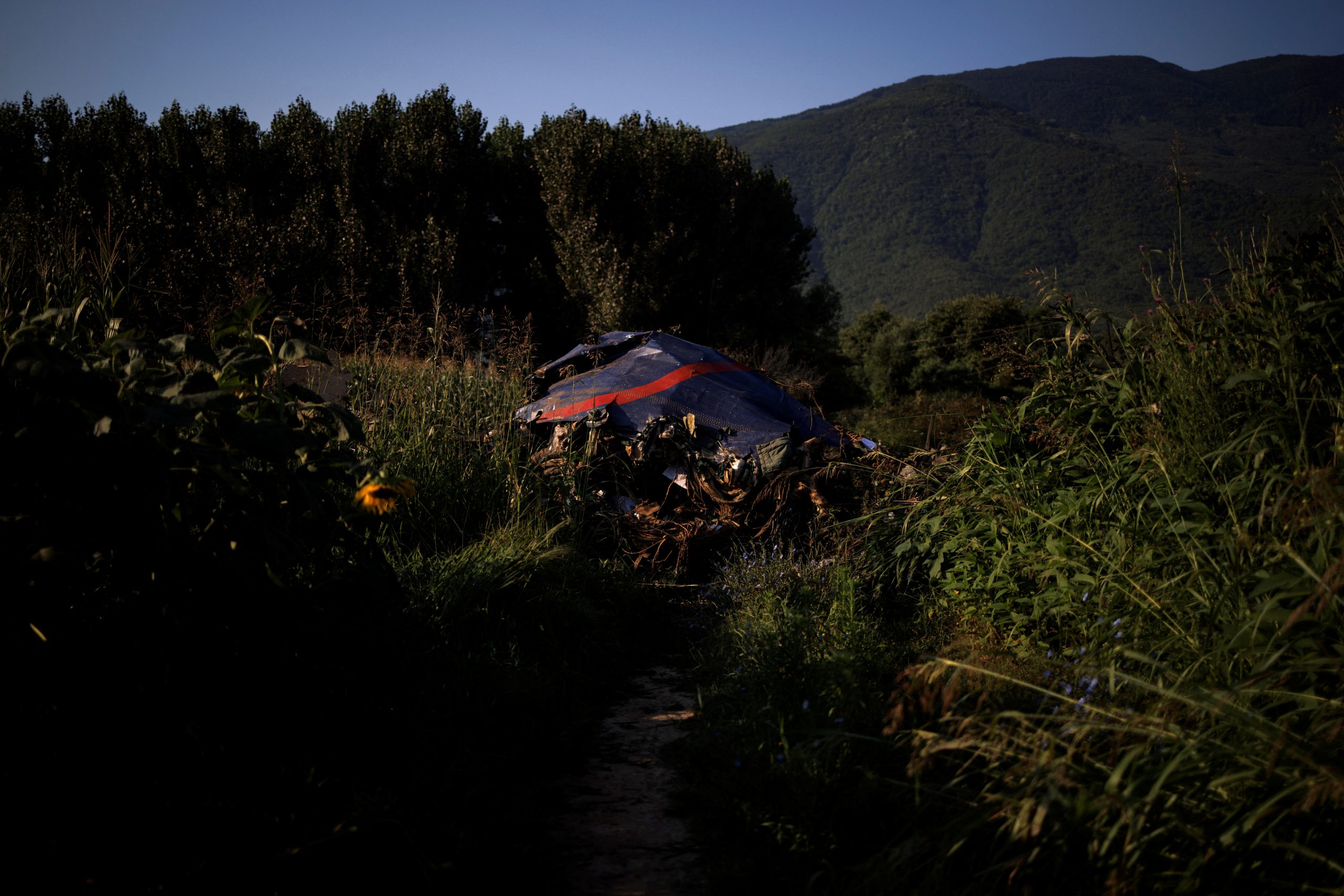 Debris is seen at the crash site of an Antonov An-12 cargo plane owned by a Ukrainian company, near Kavala, Greece, July 17, 2022. REUTERS/Alkis Konstantinidis