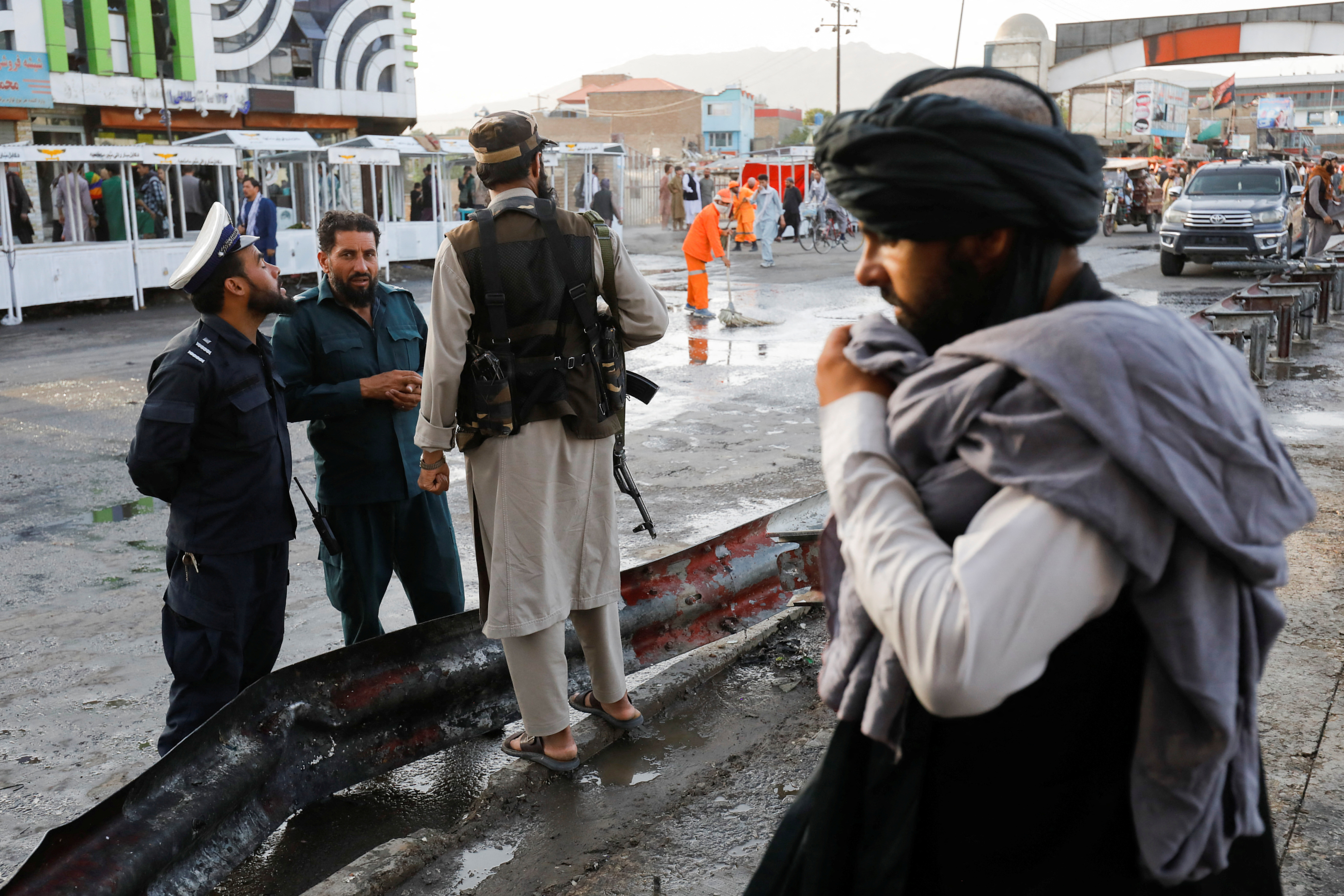 Taliban fighters stand guard at the site of a blast in Kabul, Afghanistan, August 6, 2022. REUTERS/Ali Khara