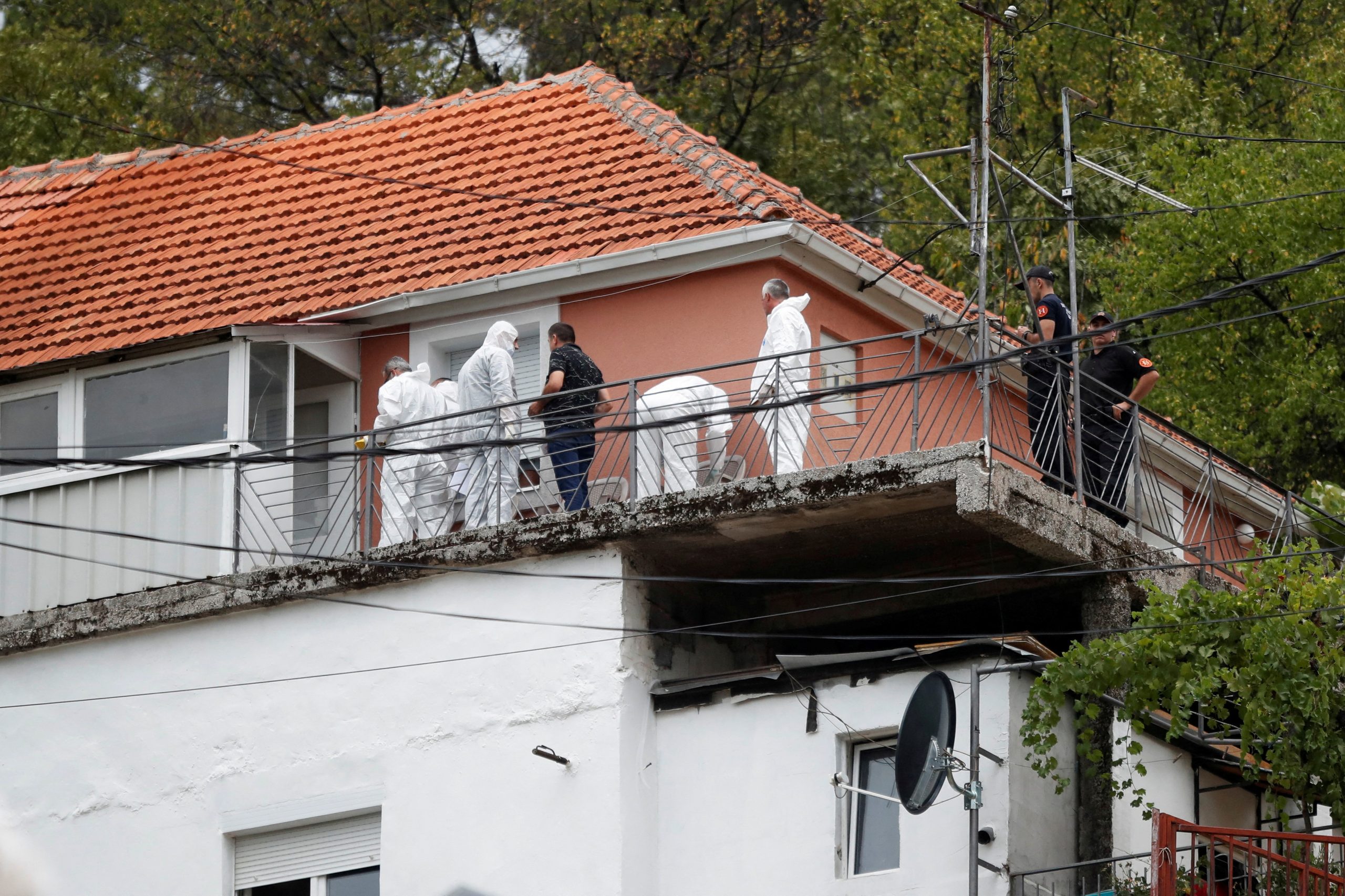 Police forensic team inspect the house where a gunman started a mass shooting in Cetinje, Montenegro August 12, 2022. REUTERS/Stevo Vasiljevic  REFILE - REMOVING NUMBER OF VICTIMS