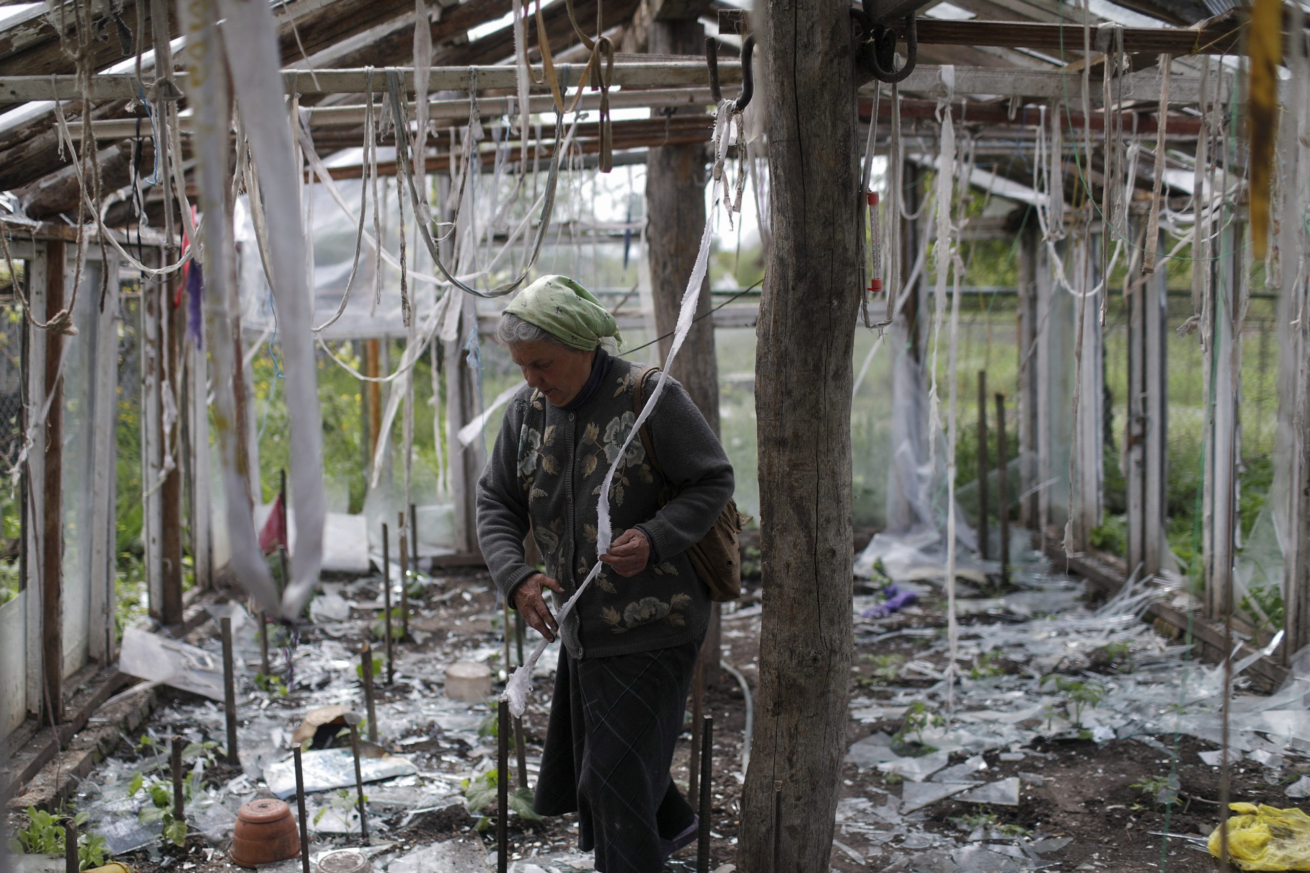 Vera Kosolopenko, reacts while looking at her destroyed greenhouse, after her house and property were hit by Russian bombing, amid Russia's attack on Ukraine, in Derhachi, near Kharkiv, Ukraine, May 14, 2022. REUTERS/Ricardo Moraes
