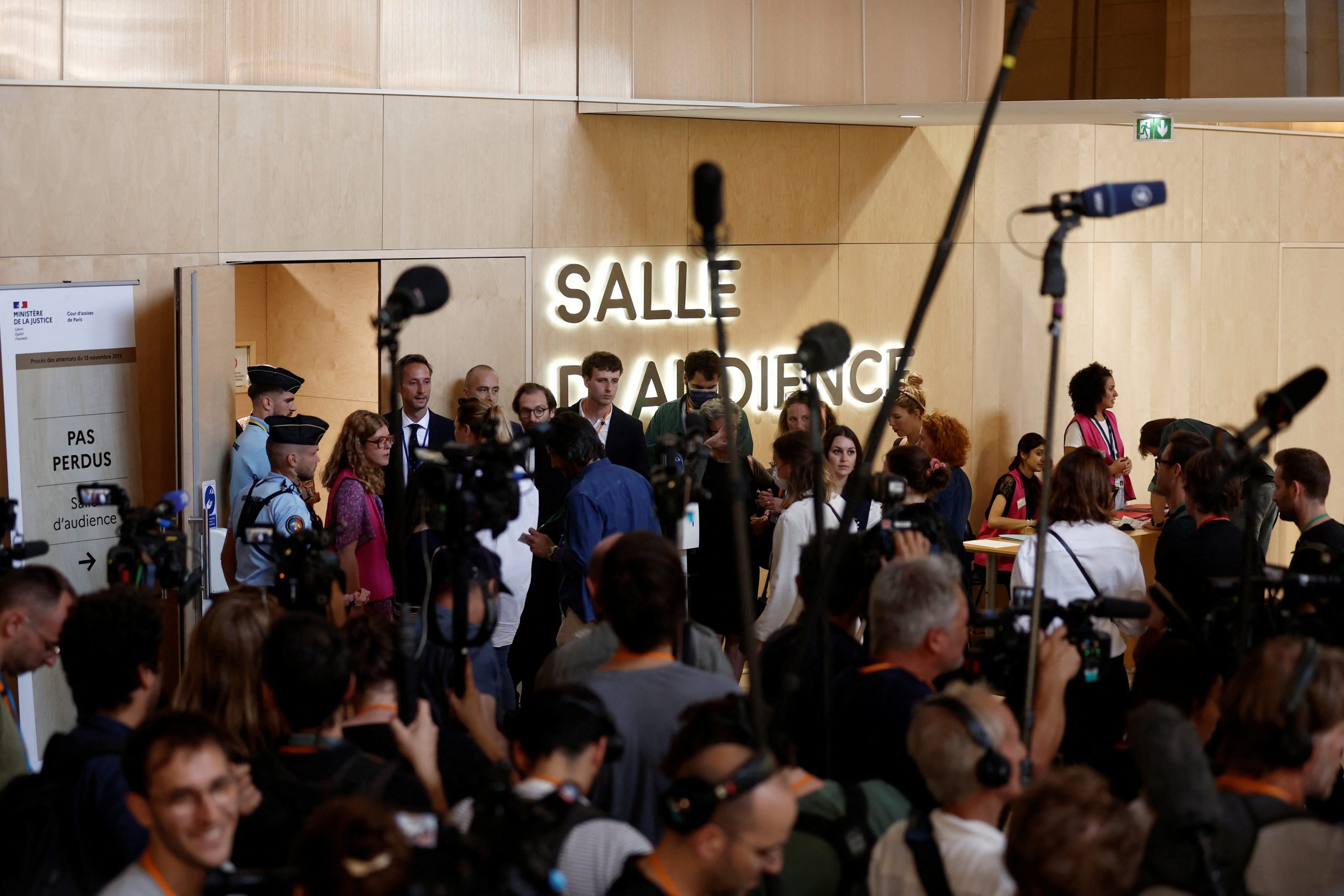 Journalists work as people queue to enter the temporary courtroom for the verdict in the trial of the Paris' November 2015 attacks at the Paris courthouse on the Ile de la Cite in Paris, France, June 29, 2022. REUTERS/Benoit Tessier