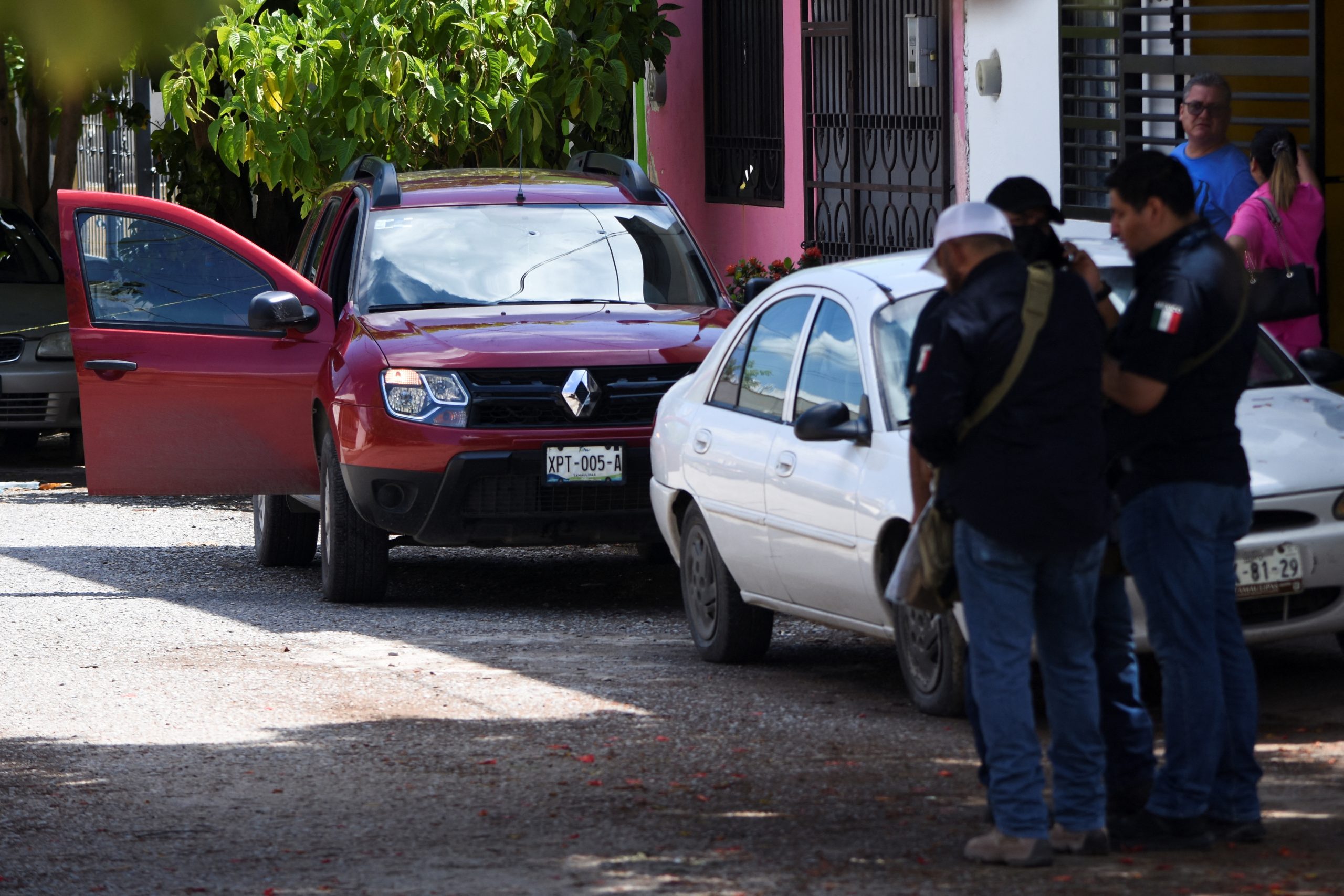 Police officers stand near the vehicle of journalist Antonio de la Cruz, who was killed by unknown assailants while leaving his home, in Ciudad Victoria, in Tamaulipas state, Mexico June 29, 2022. REUTERS/Stringer NO RESALES. NO ARCHIVES