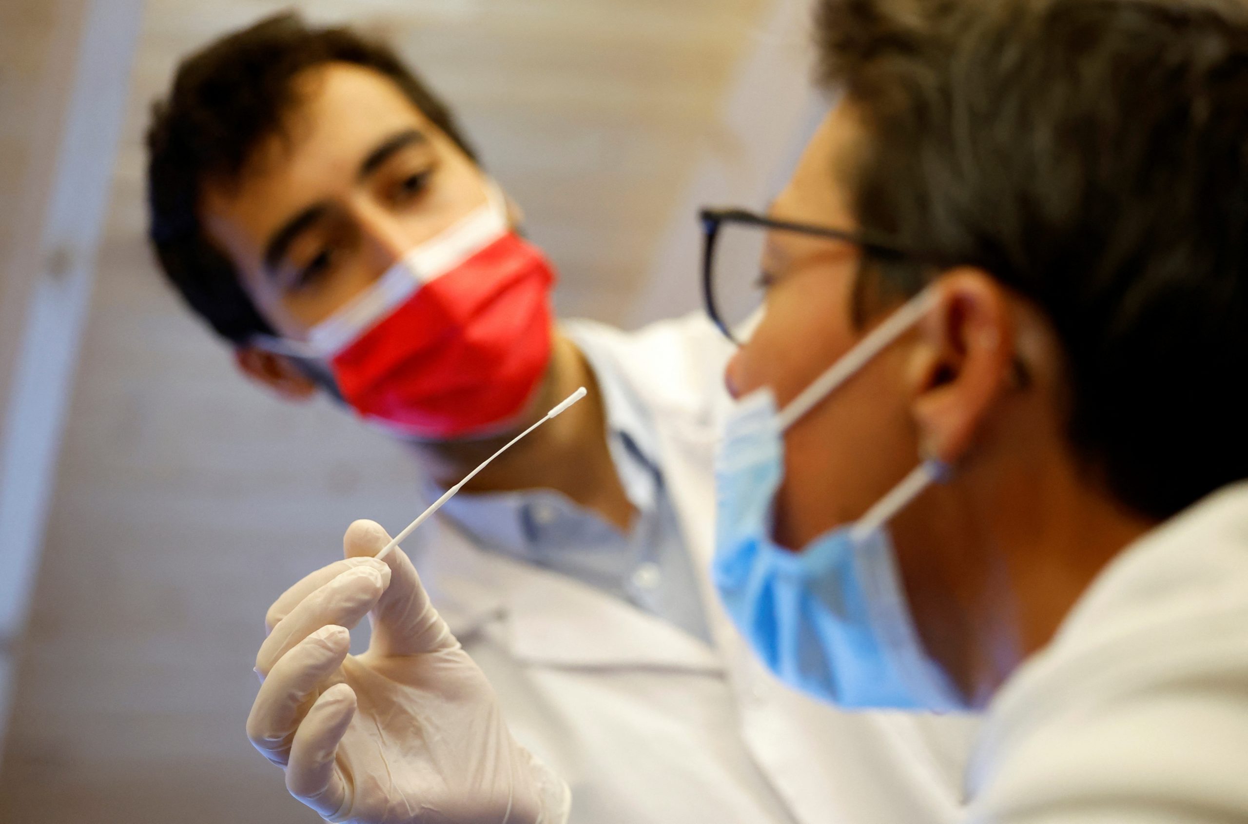 A medical worker administers a nasal swab to a patient at a coronavirus disease (COVID-19) testing centre in Nantes, near Nantes, France, June 30, 2022. REUTERS/Stephane Mahe