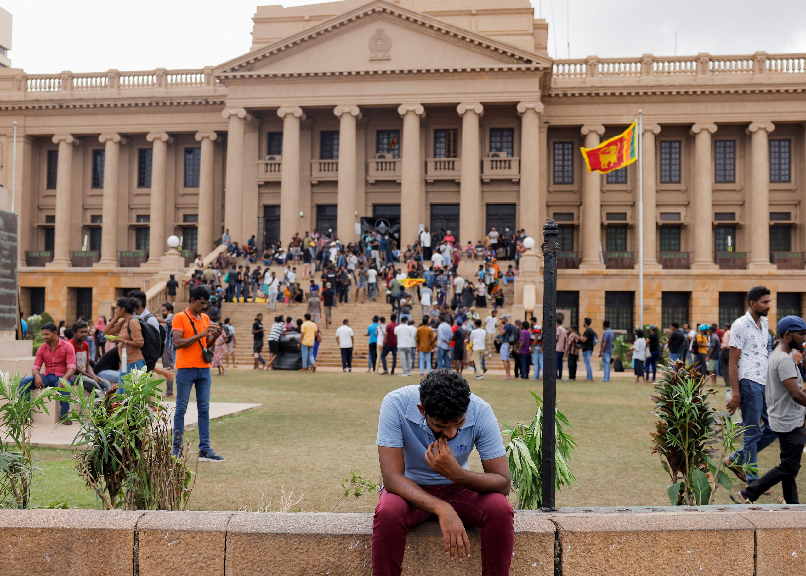 A demonstrator rests after entering the Presidential Secretariat premises, after President Gotabaya Rajapaksa fled, amid the country's economic crisis, in Colombo, Sri Lanka July 10, 2022. REUTERS/Dinuka Liyanawatte