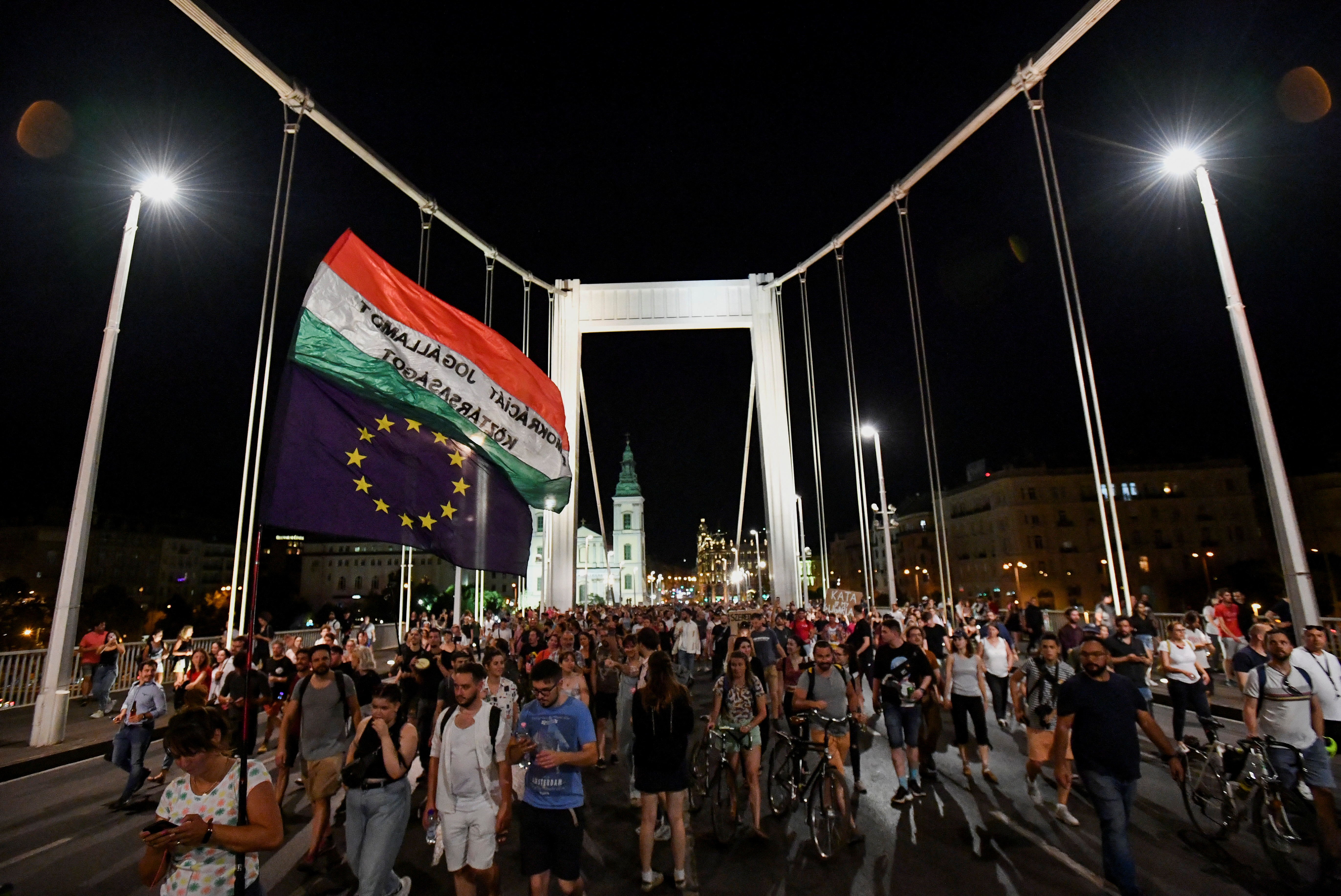 People gather at Elisabeth Bridge during an anti-governmental protest after a move by the Hungarian government to tighten a favorable tax rate offered to small businesses, in Budapest, Hungary July 13, 2022. REUTERS/Marton Monus