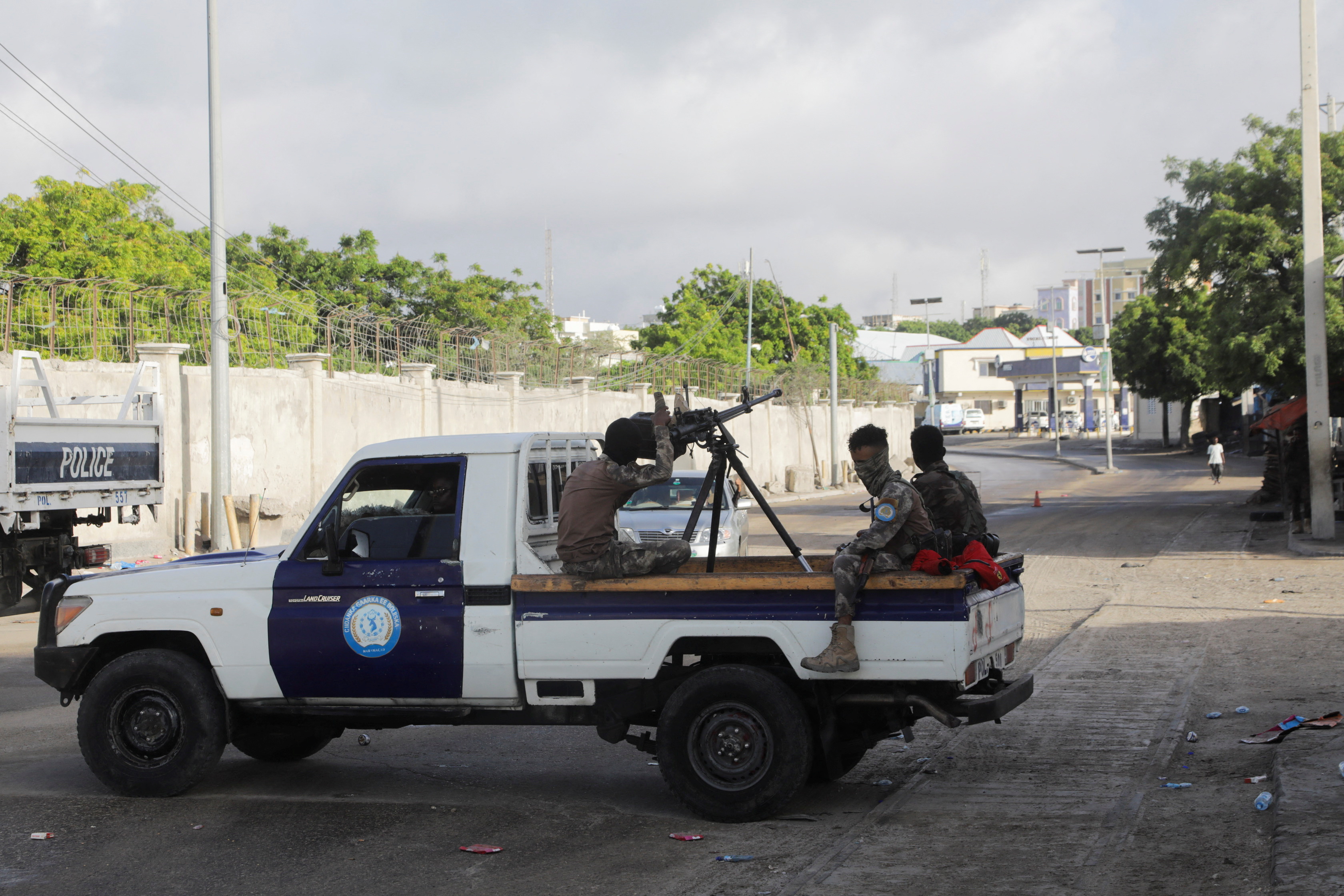 Somali policemen sit on a pickup truck as they enforce a curfew on the day of the Somali presidential elections, in Mogadishu, Somalia May 15, 2022. REUTERS/Feisal Omar