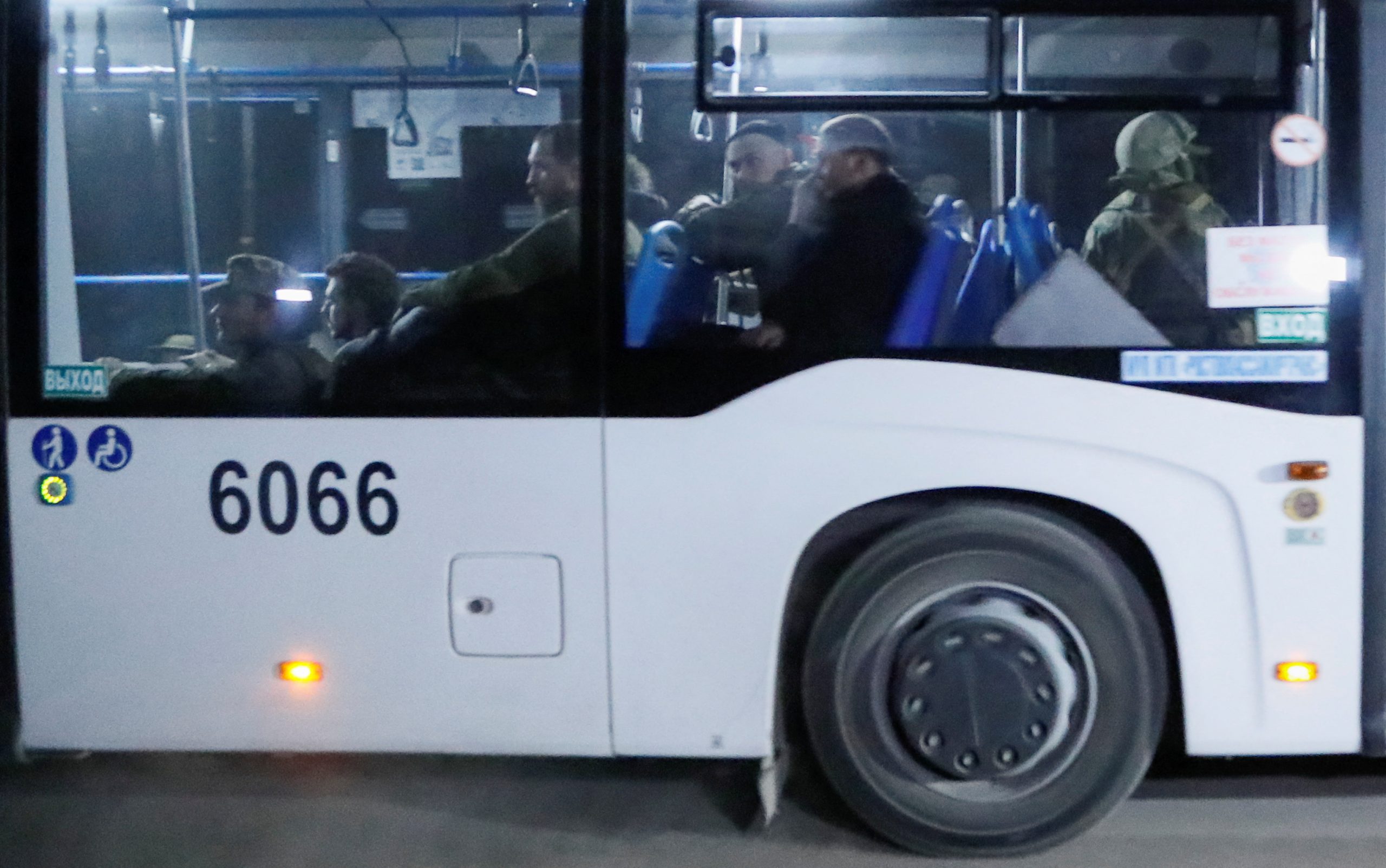 A bus carrying service members of Ukrainian forces from the besieged Azovstal steel mill drives away under escort of the pro-Russian military in the course of Ukraine-Russia conflict in Mariupol, Ukraine May 16, 2022. REUTERS/Alexander Ermochenko