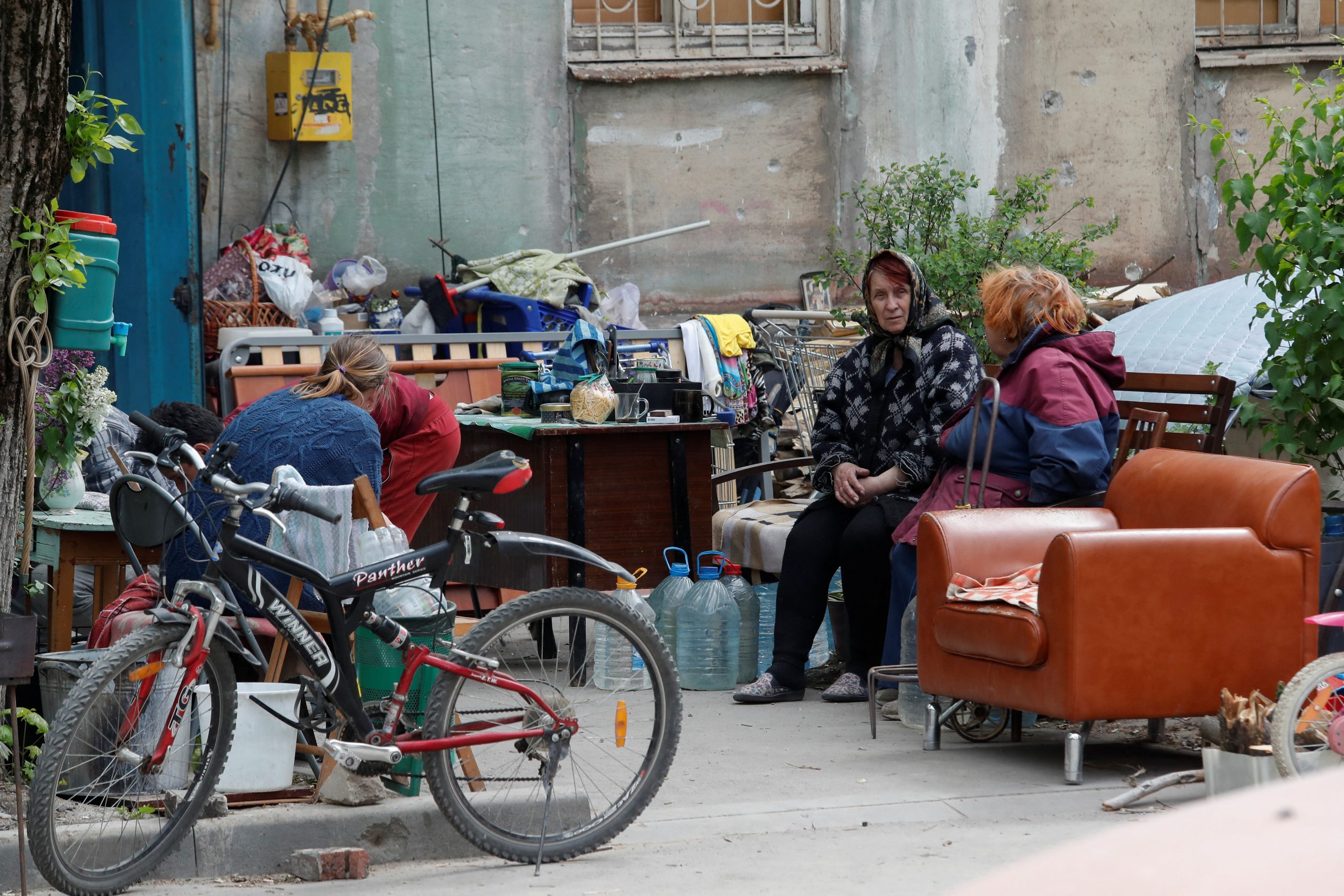 Local residents gather in a courtyard in the course of Ukraine-Russia conflict in the southern port city of Mariupol, Ukraine May 11, 2022. REUTERS/Alexander Ermochenko