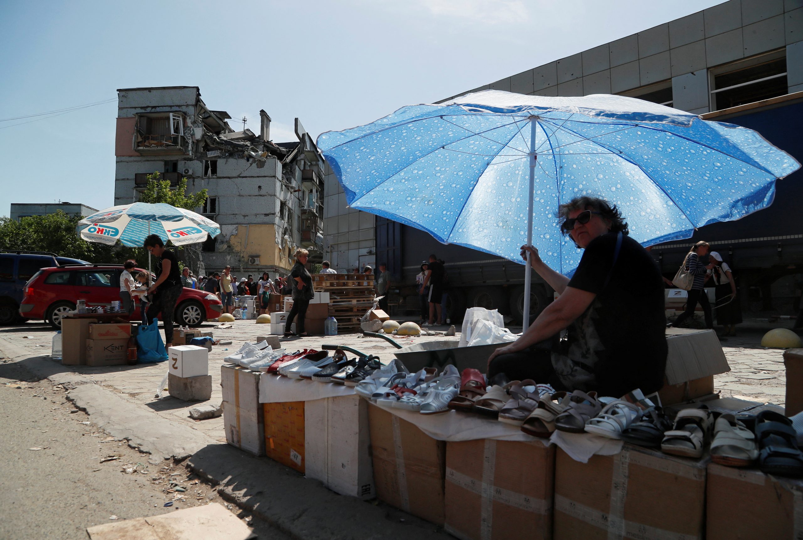 A street vendor sells footwear during Ukraine-Russia conflict in the southern port city of Mariupol, Ukraine May 30, 2022. REUTERS/Alexander Ermochenko