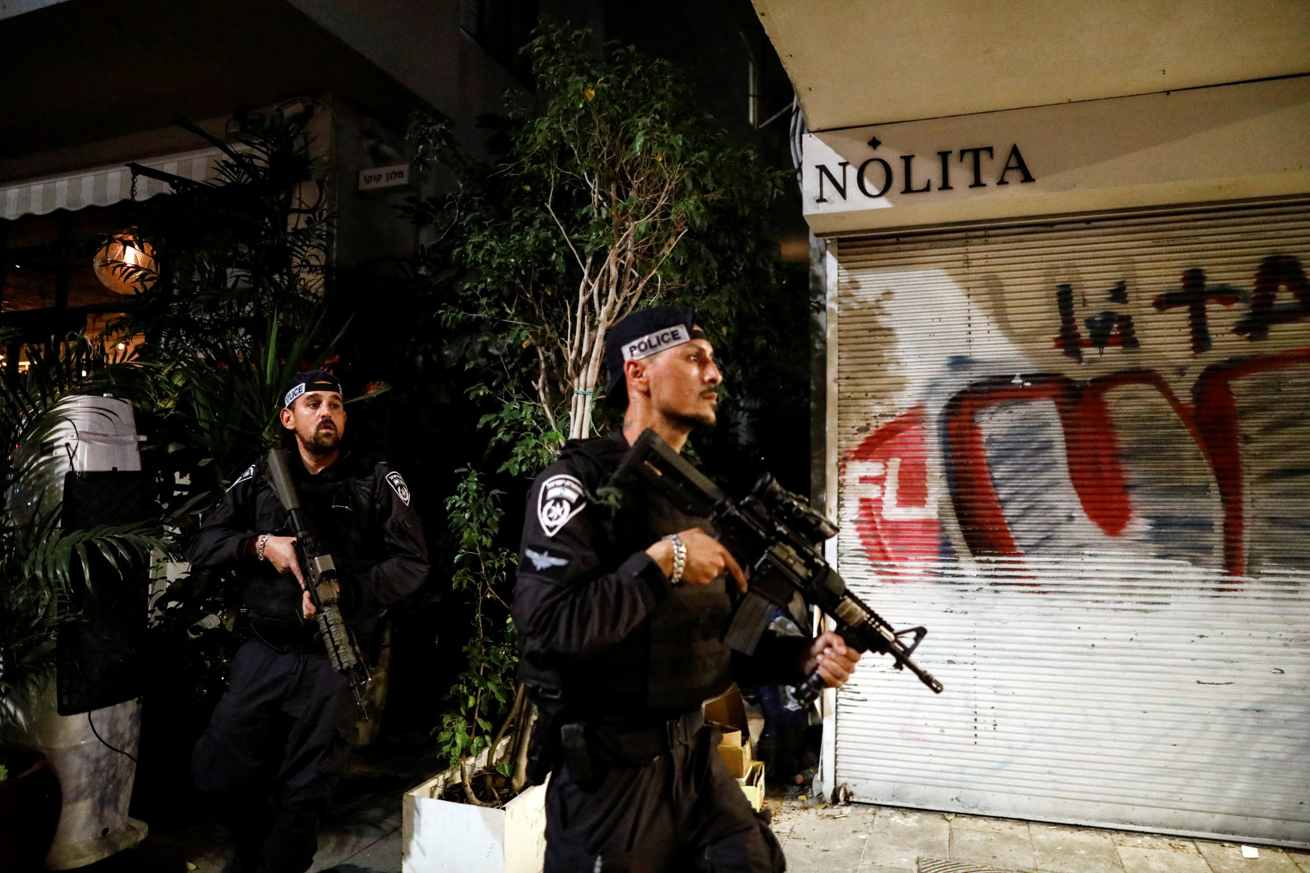Israeli security personnel work near the scene of a fatal shooting attack near a bar in Tel Aviv, Israel April 7, 2022. REUTERS/Corinna Kern