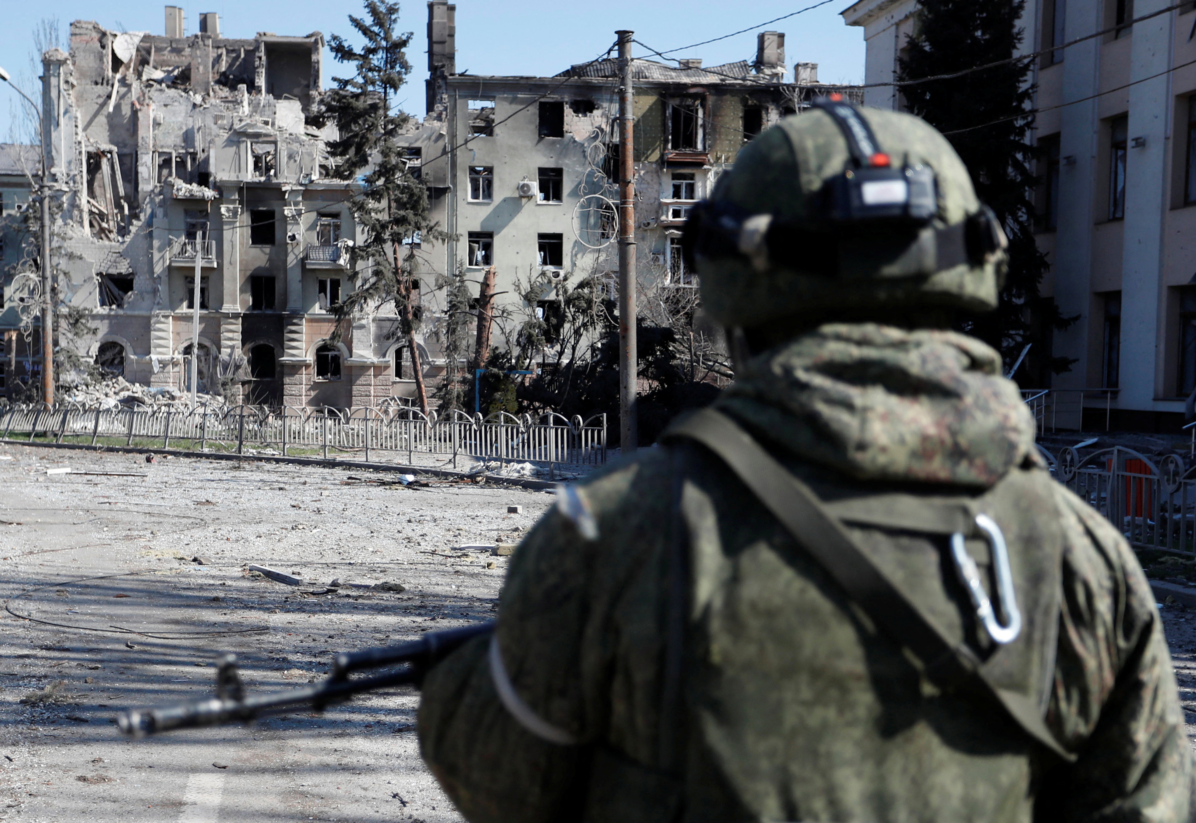 A service member of pro-Russian troops inspects the street during Ukraine-Russia conflict in the southern port city of Mariupol, Ukraine April 7, 2022. REUTERS/Alexander Ermochenko