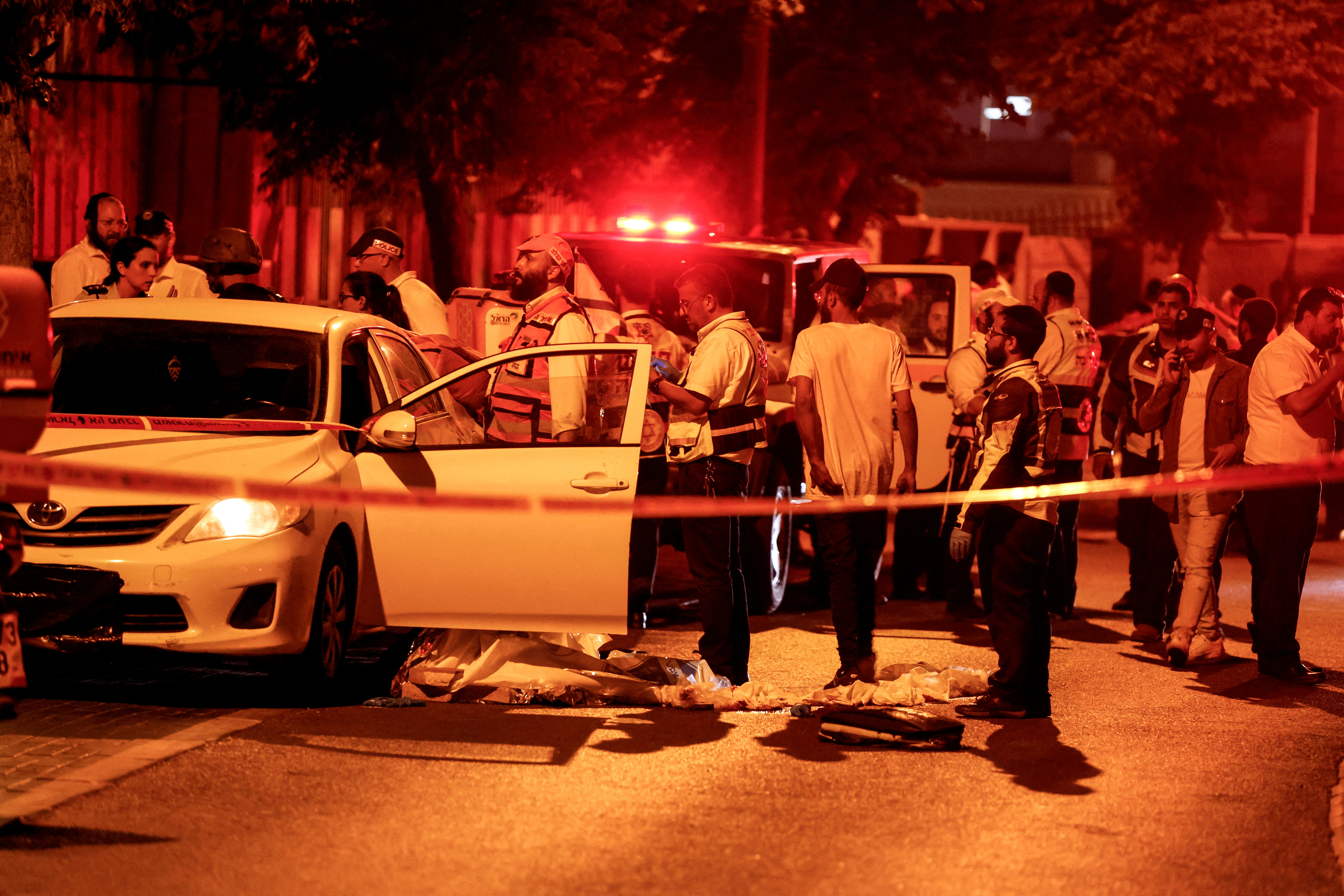 Israeli Security and rescue personnel work at the scene following an incident in Elad, in central Israel, May 5, 2022. REUTERS/Ammar Awad