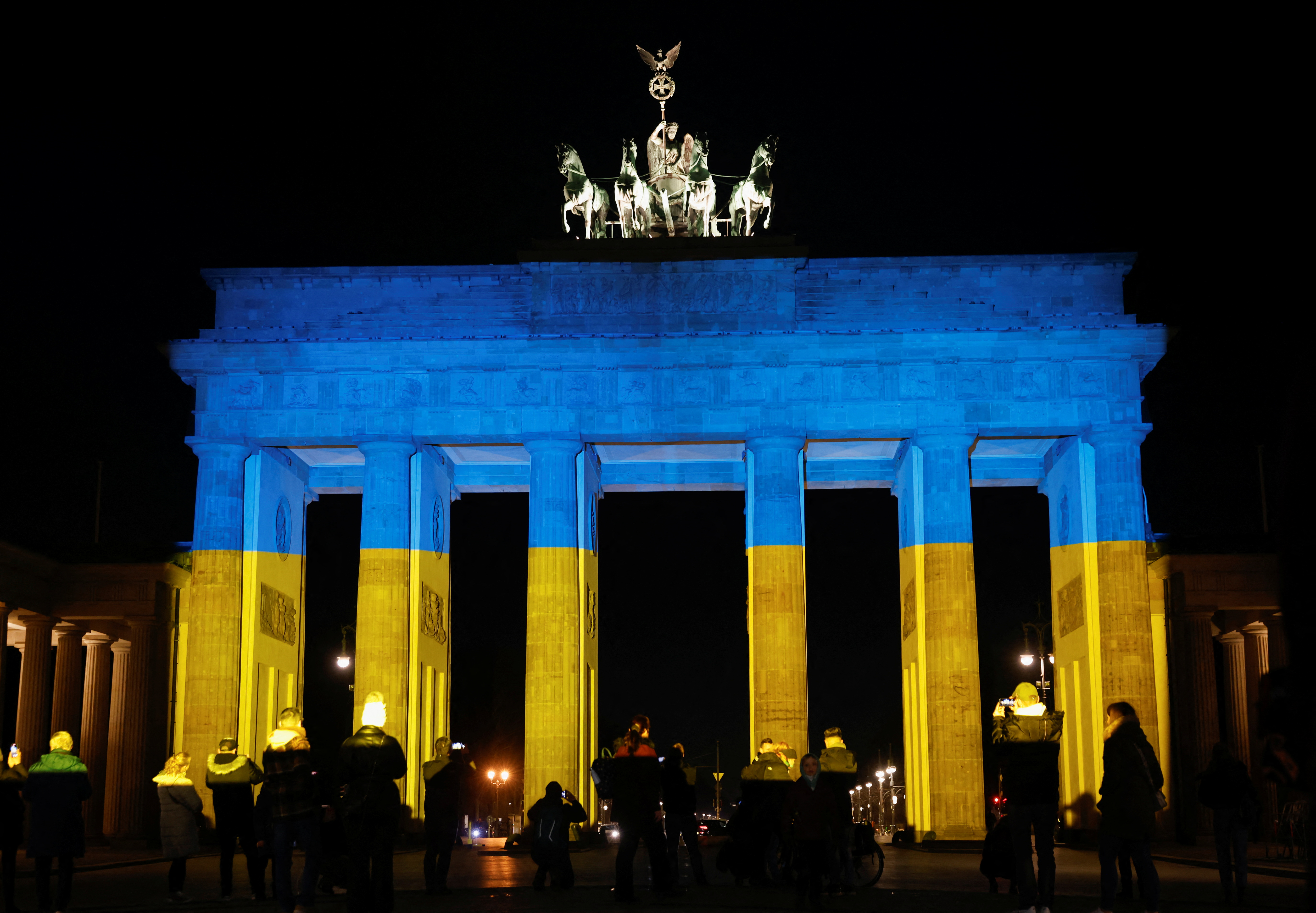The Brandenburg Gate is illuminated in Ukrainian national colors, in Berlin, Germany February 23, 2022. REUTERS/Michele Tantussi