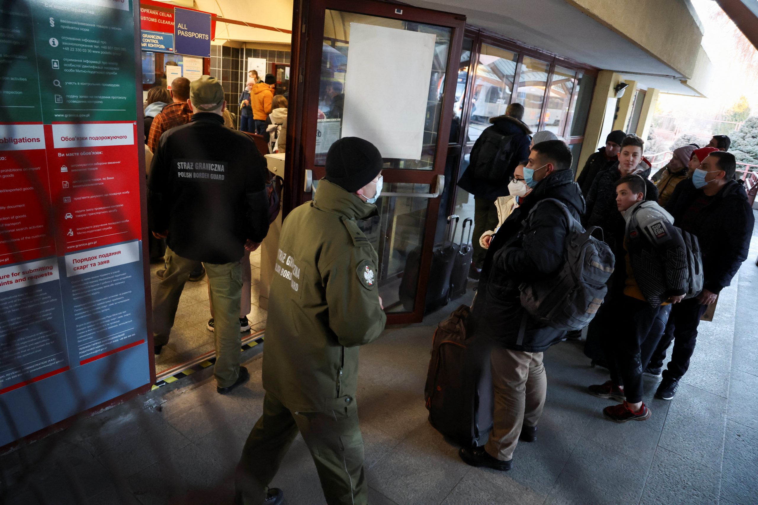 People line up at the customs clearance center after arriving by train from Ukraine, in Przemysl, Poland, February 24, 2022. REUTERS/Kacper Pempel