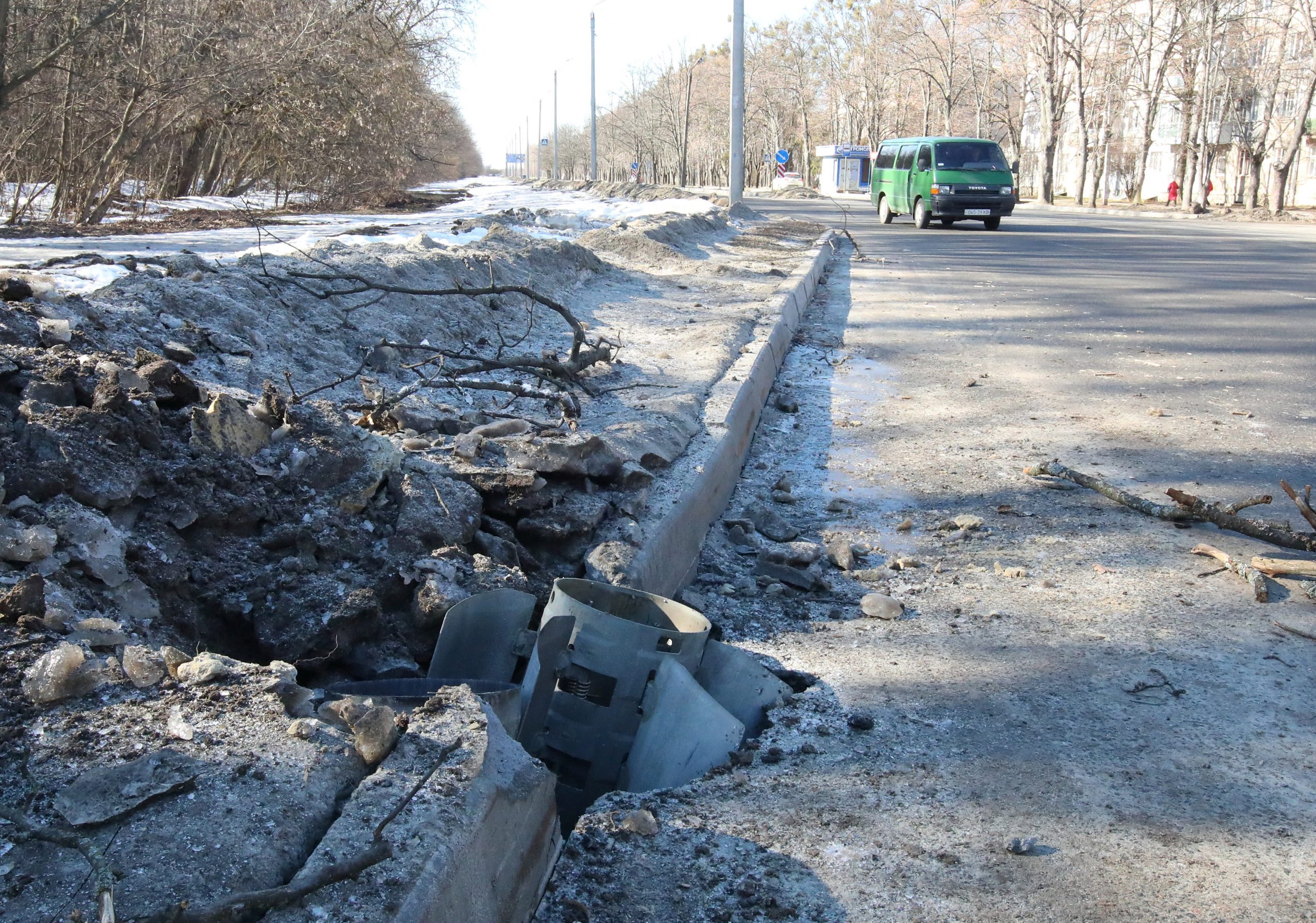 A rocket case lies buried into a road after recent shelling in Kharkiv, Ukraine February 24, 2022.  REUTERS/Vyacheslav Madiyevskyy
