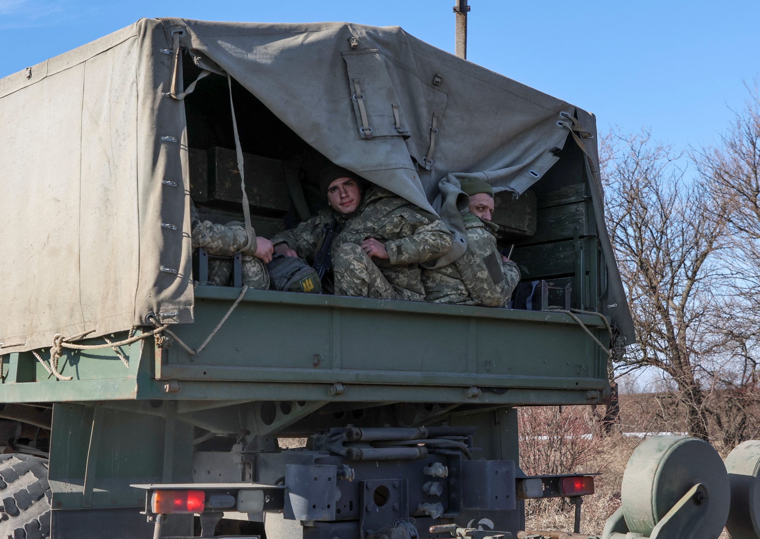 Ukrainian army soldier sits in a truck, after Russian President Vladimir Putin authorised a military operation, in eastern Ukraine, in Kharkiv region, Ukraine February 24, 2022. REUTERS/Antonio Bronic