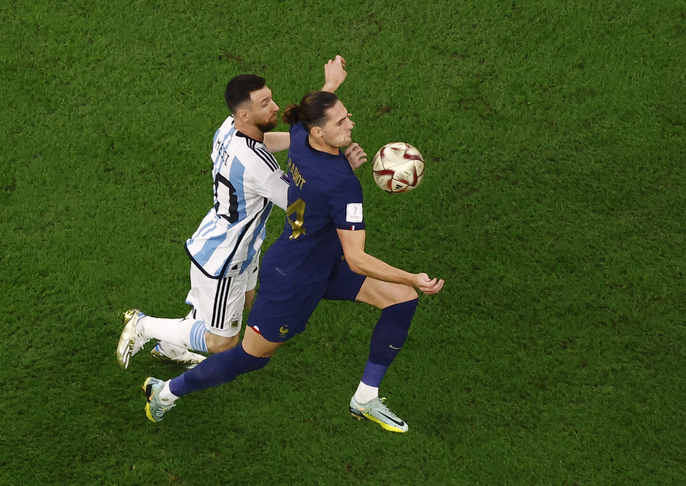 Soccer Football - FIFA World Cup Qatar 2022 - Final - Argentina v France - Lusail Stadium, Lusail, Qatar - December 18, 2022 Argentina's Lionel Messi in action with France's Adrien Rabiot REUTERS/Peter Cziborra