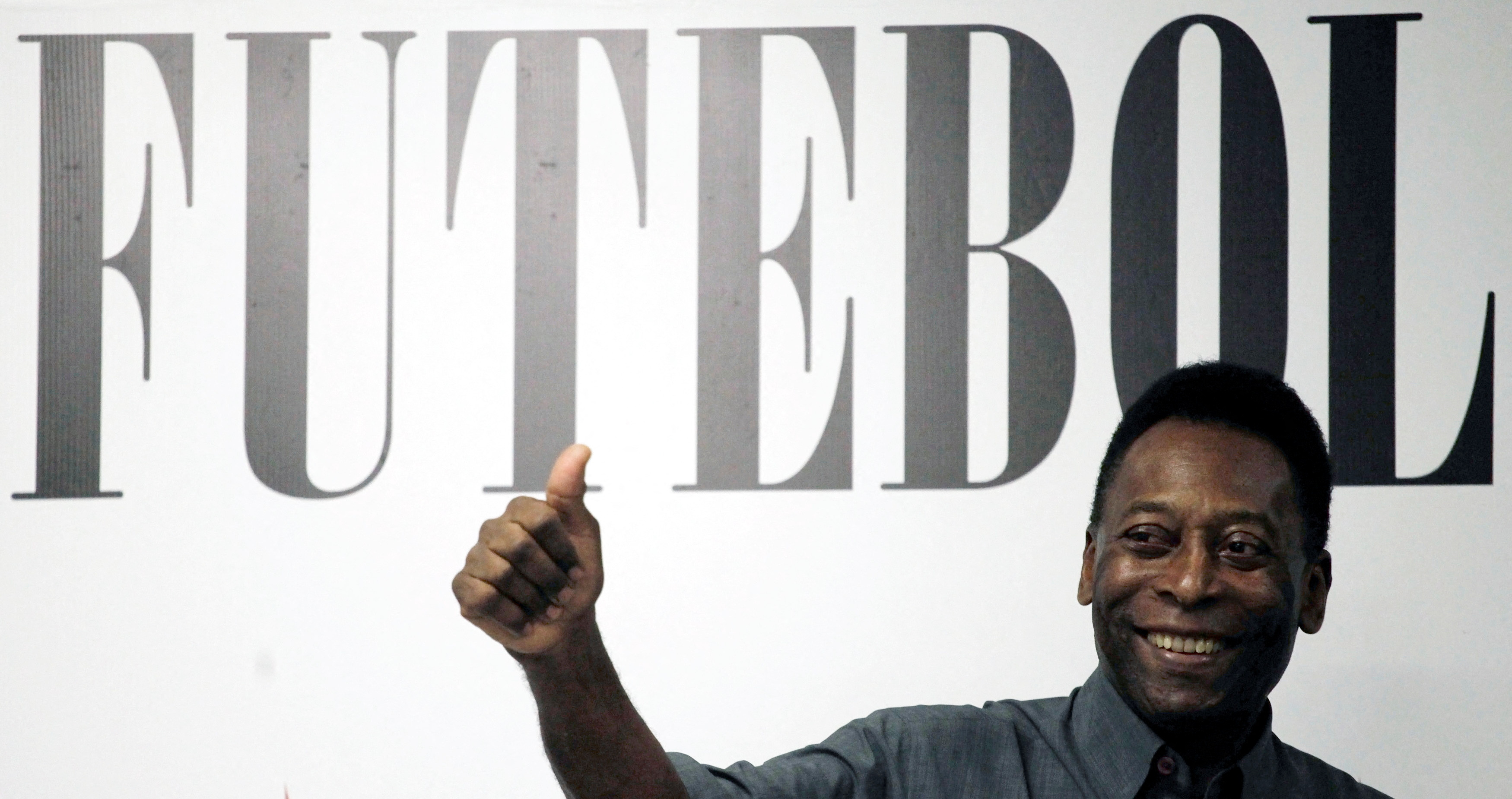 FILE PHOTO: Soccer legend Pele gives a thumbs up during a ceremony to celebrate the 100th anniversary of Brazilian soccer club Santos, in Santos, Brazil, April 9, 2012. The word in the background reads "football". REUTERS/Nacho Doce/File Photo