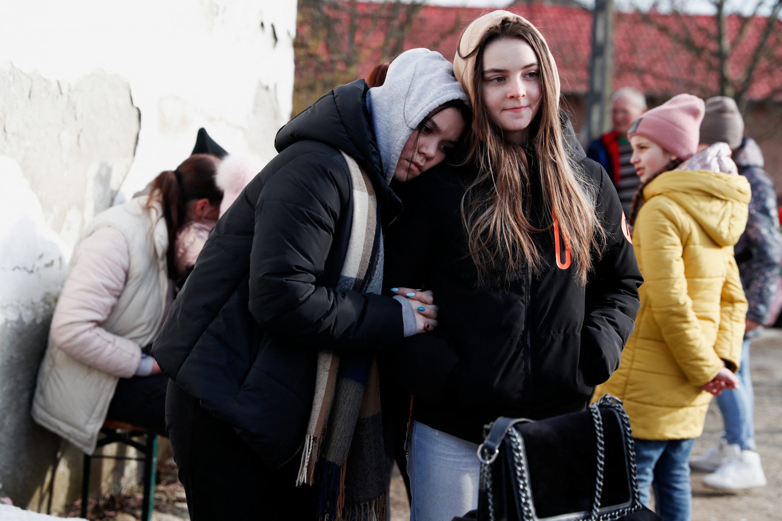 Girls fleeing from Ukraine wait near a refugee shelter, after Russia's invasion of Ukraine, in Tiszabecs, Hungary, March 2, 2022. REUTERS/Bernadett Szabo