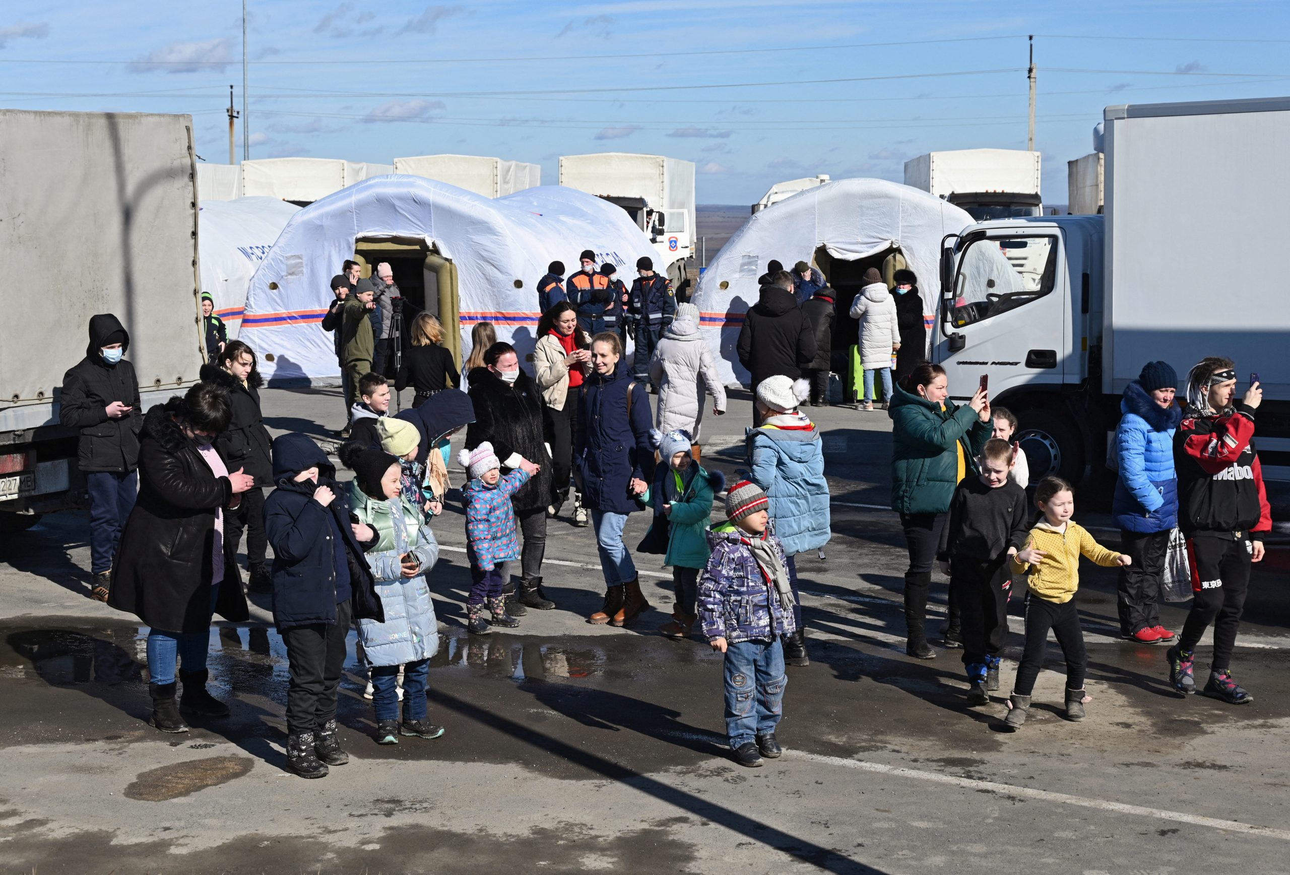 People evacuated from separatist-controlled regions in eastern Ukraine are seen in a tent camp set up by the Russian Emergencies Ministry near the Matveyev Kurgan border checkpoint in the Rostov region, Russia February 19, 2022. REUTERS/Sergey Pivovarov