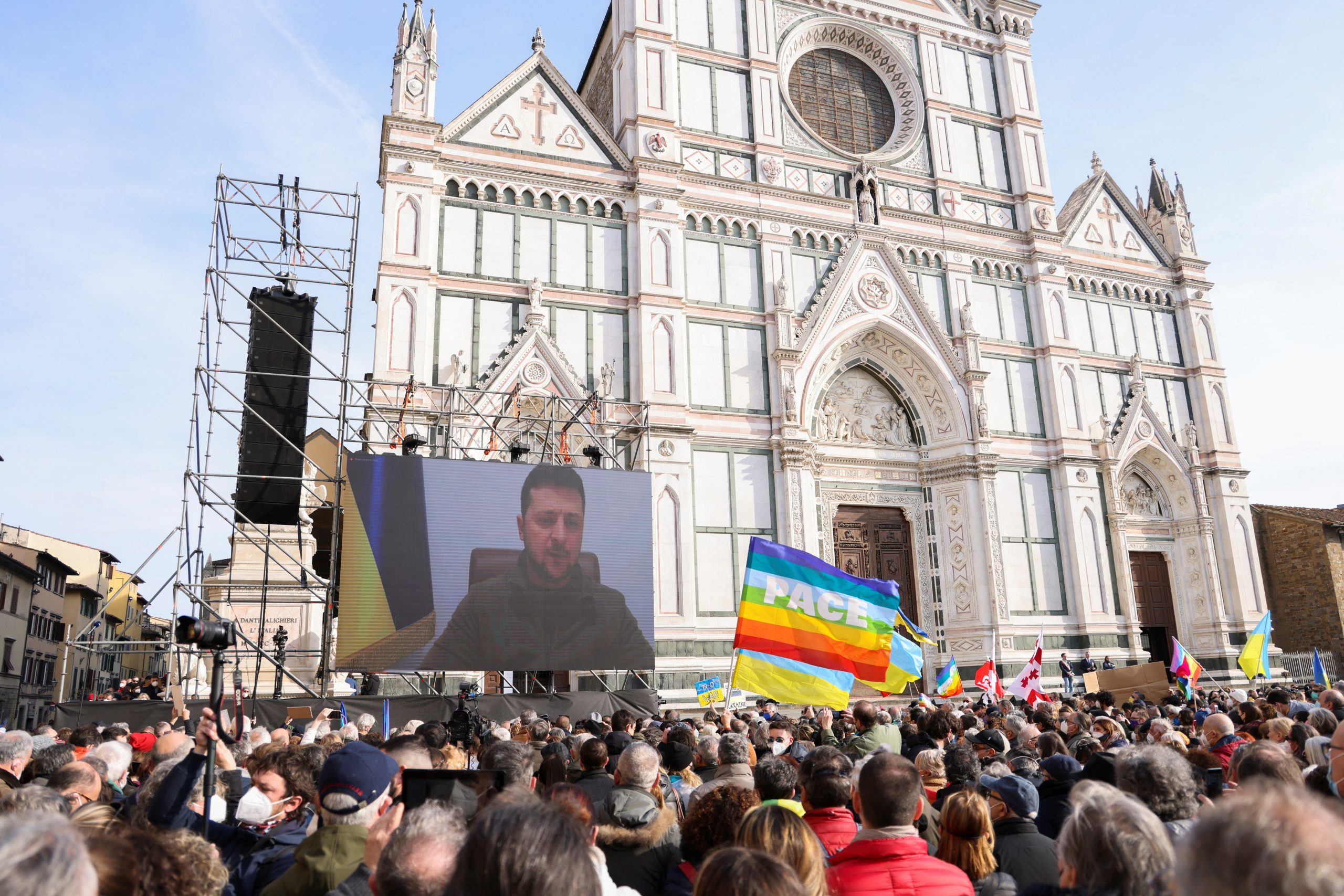Ukrainian President Volodymyr Zelenskiy addresses demonstrators via video as they gather in Santa Croce square to protest against the Russian invasion of Ukraine, in Florence, Italy, March 12, 2022. REUTERS/Chiara Negrello