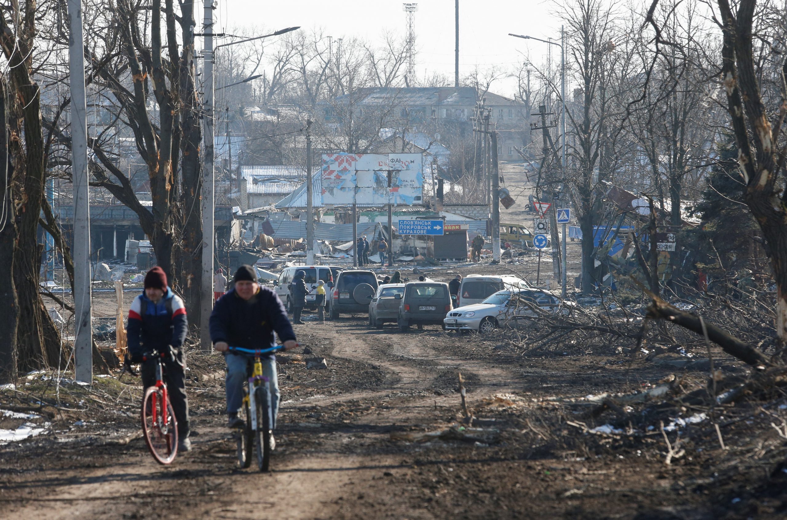 People ride bicycles in the separatist-controlled town of Volnovakha in the Donetsk region, Ukraine March 12, 2022. REUTERS/Alexander Ermochenko