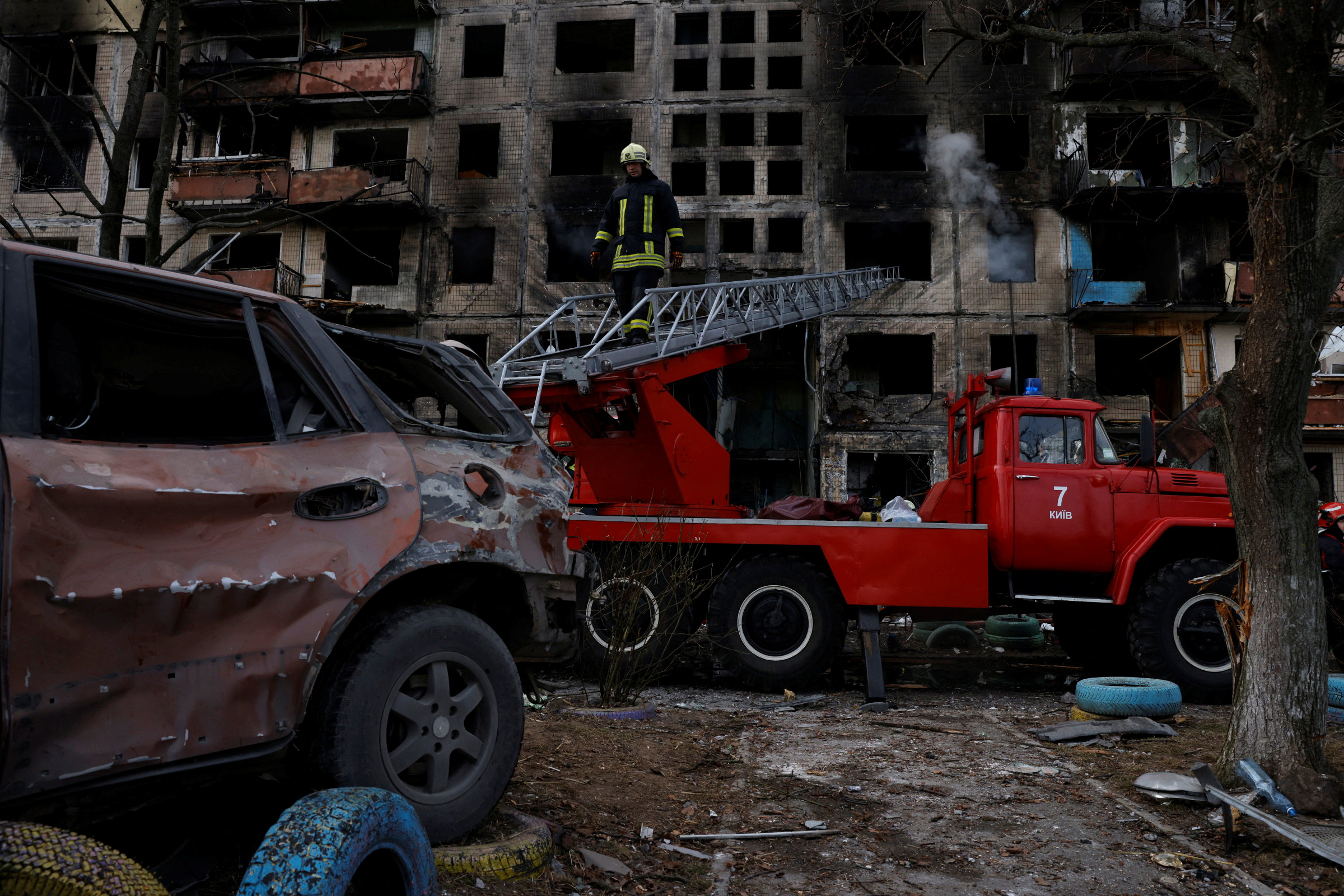 A firefighter leaves a residential building that was hit by a shell in the Obolon district of Kyiv as Russia's invasion contiunes, Ukraine, March 14, 2022. REUTERS/Thomas Peter