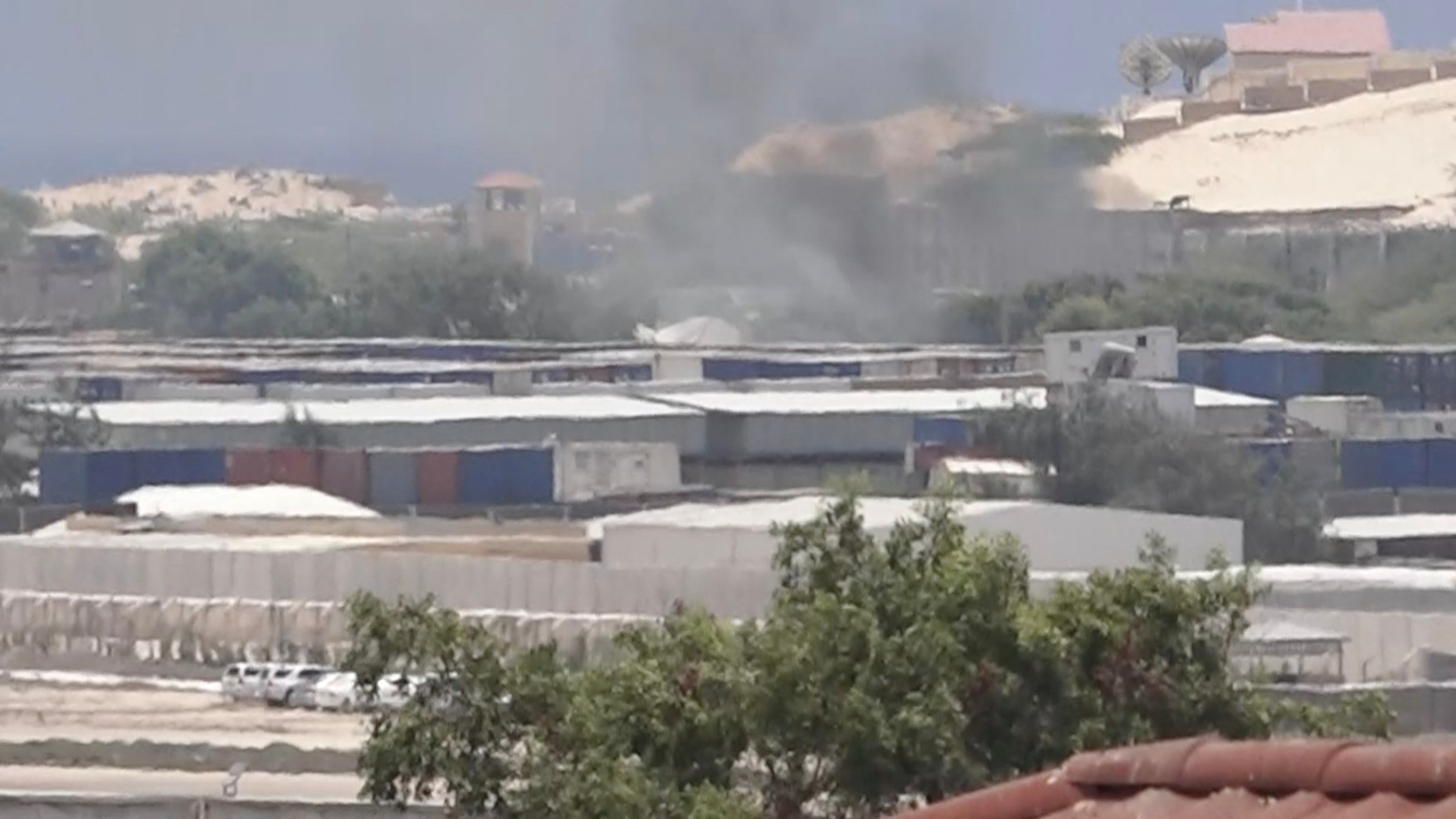 Smoke rises from behind buildings, in Mogadishu, Somalia, March 23, 2022, in this still image obtained from a social media video. Twitter/@Hajishire/via REUTERS  THIS IMAGE HAS BEEN SUPPLIED BY A THIRD PARTY. MANDATORY CREDIT.