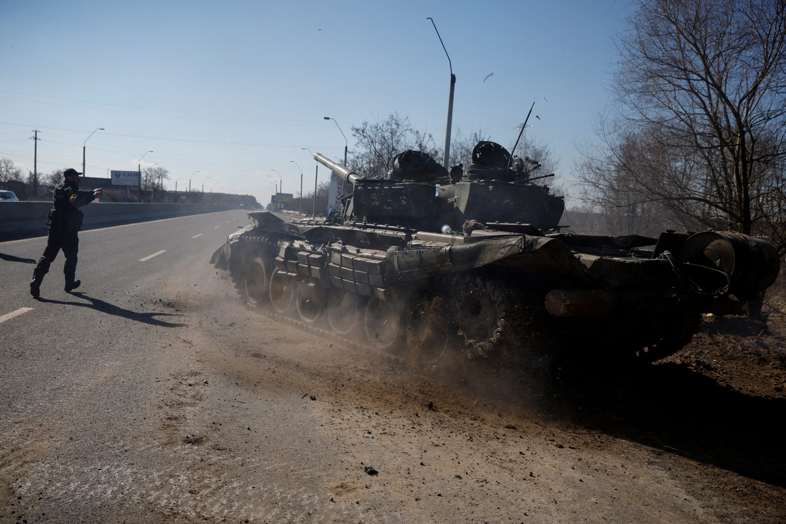FILE PHOTO: A Ukrainian soldier directs a Russian tank that Ukrainians captured after fighting with Russian troops, as Russia's attack on Ukraine continues, outside Brovary, near Kyiv, Ukraine, March 10, 2022. REUTERS/Thomas Peter/File Photo