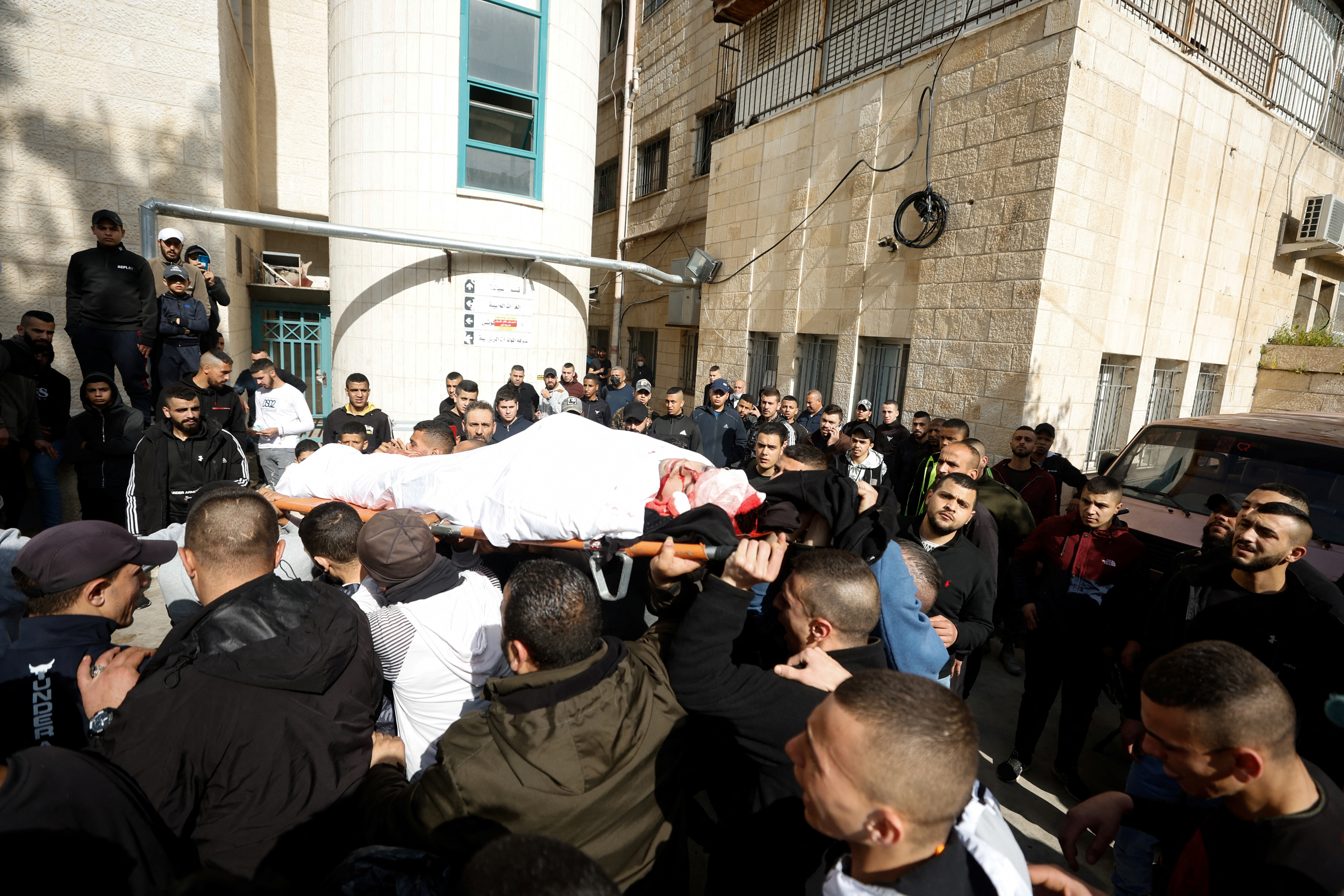 SENSITIVE MATERIAL. THIS IMAGE MAY OFFEND OR DISTURB Relatives carry the body of a Palestinian man who, according to medics, was killed by Israeli forces during a raid, in Jenin in the Israeli- occupied West Bank, March 31, 2022. REUTERS/Mohamad Torokman