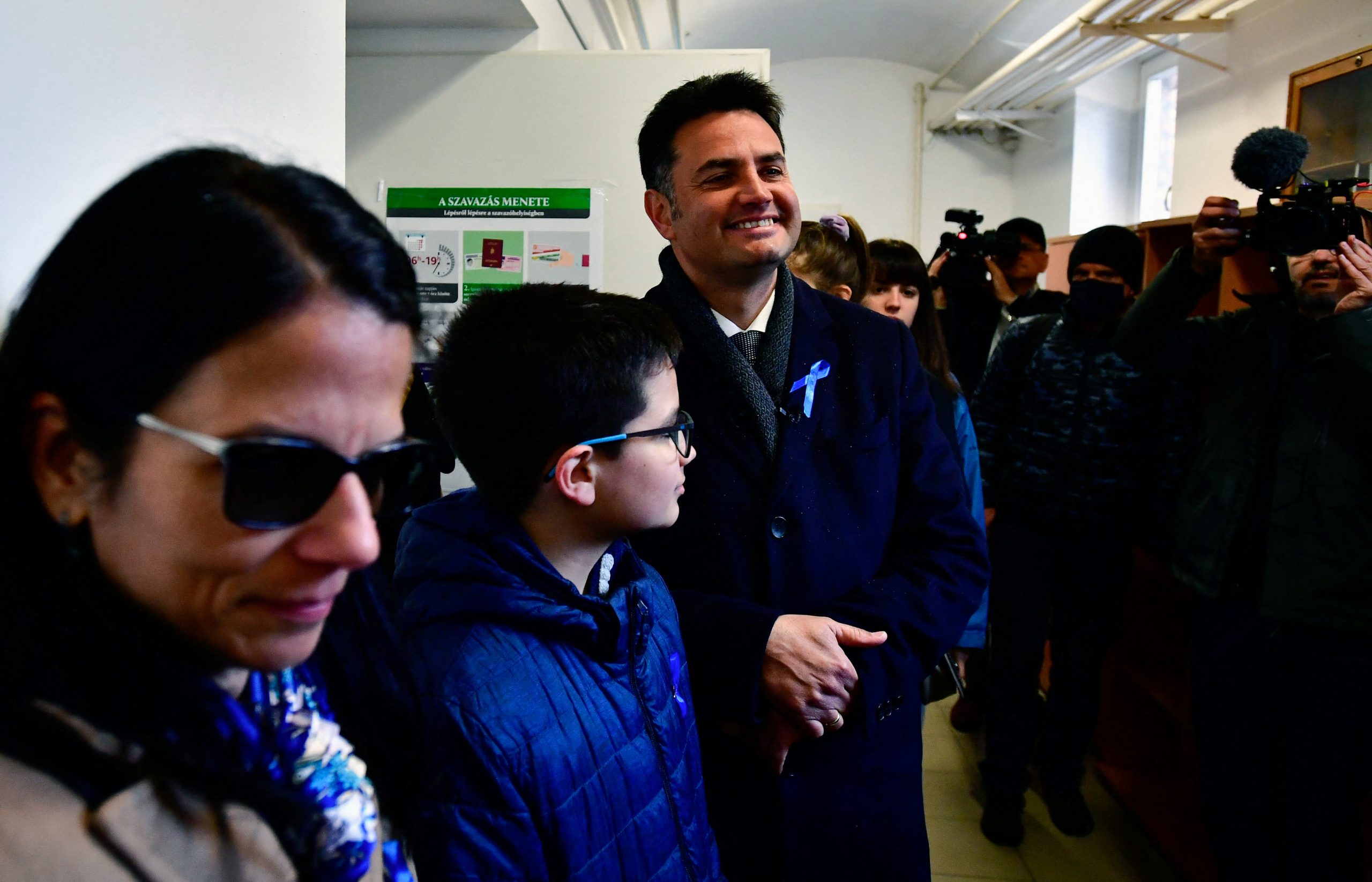 Opposition candidate for prime minister Peter Marki-Zay, accompanied by his wife and son, smiles as he waits to cast his ballot during Hungarian parliamentary election in Hodmezovasarhely, Hungary, April 3, 2022. REUTERS/Monus Marton