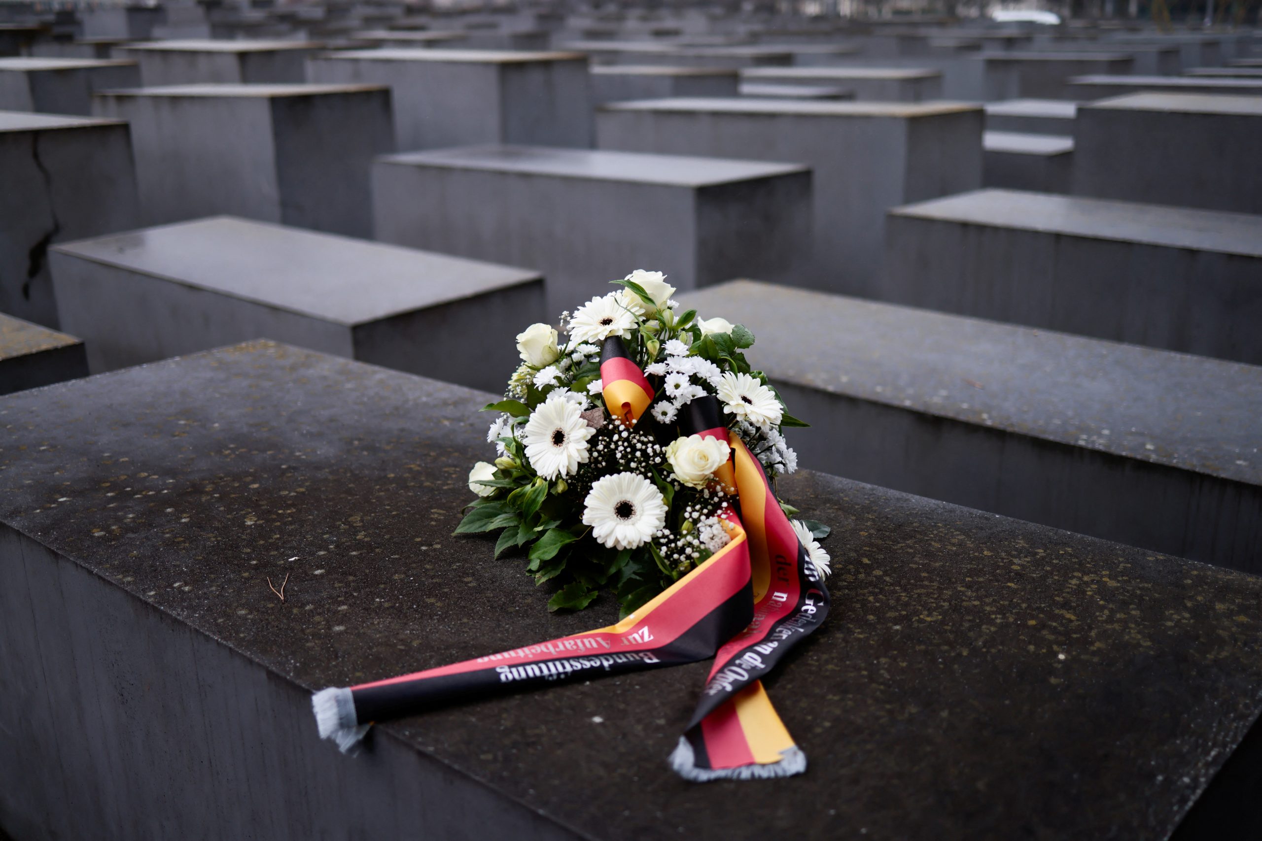 Flowers are seen at the Memorial to the Murdered Jews of Europe on Holocaust Remembrance Day , in Berlin, Germany, January 27, 2022. REUTERS/Hannibal Hanschke