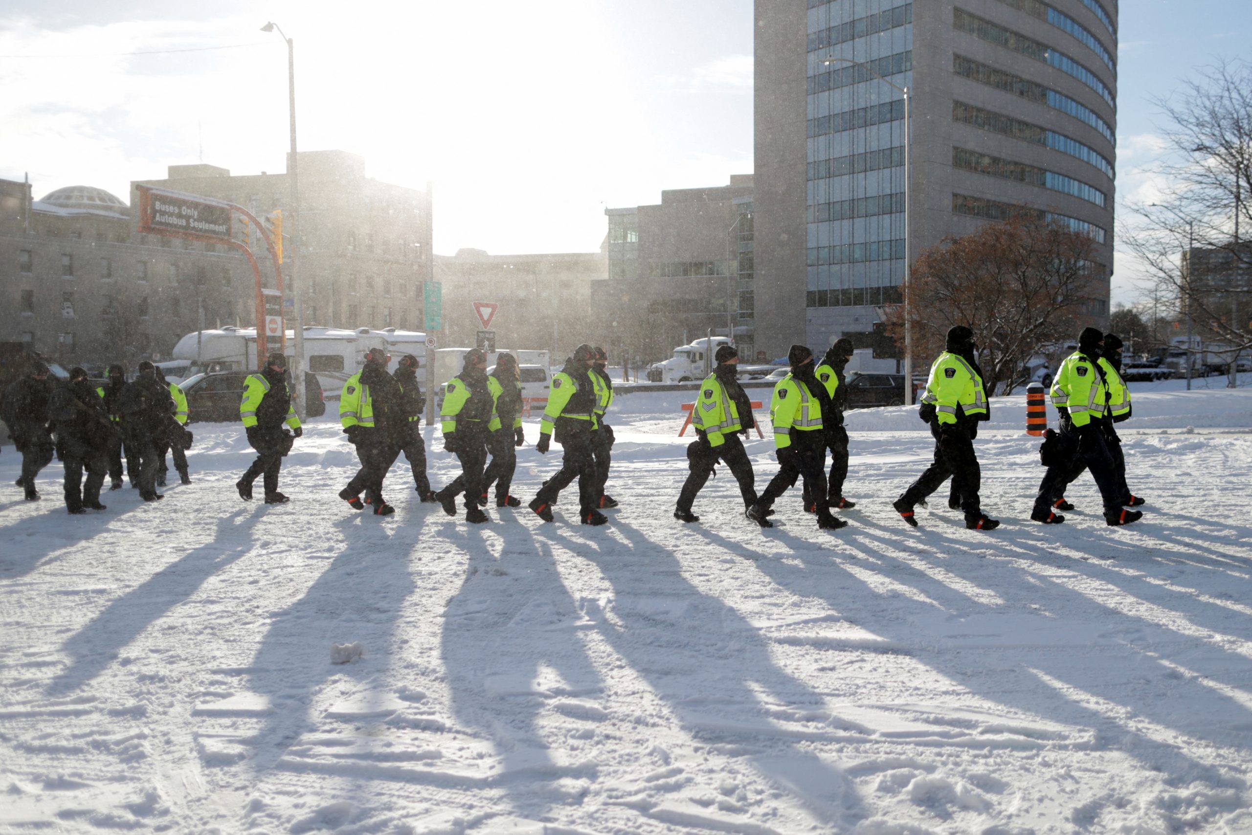Police officers walk on a street, as truckers and supporters continue to protest coronavirus disease (COVID-19) vaccine mandates, in Ottawa, Ontario, Canada, February 18, 2022. REUTERS/Carlos Osorio