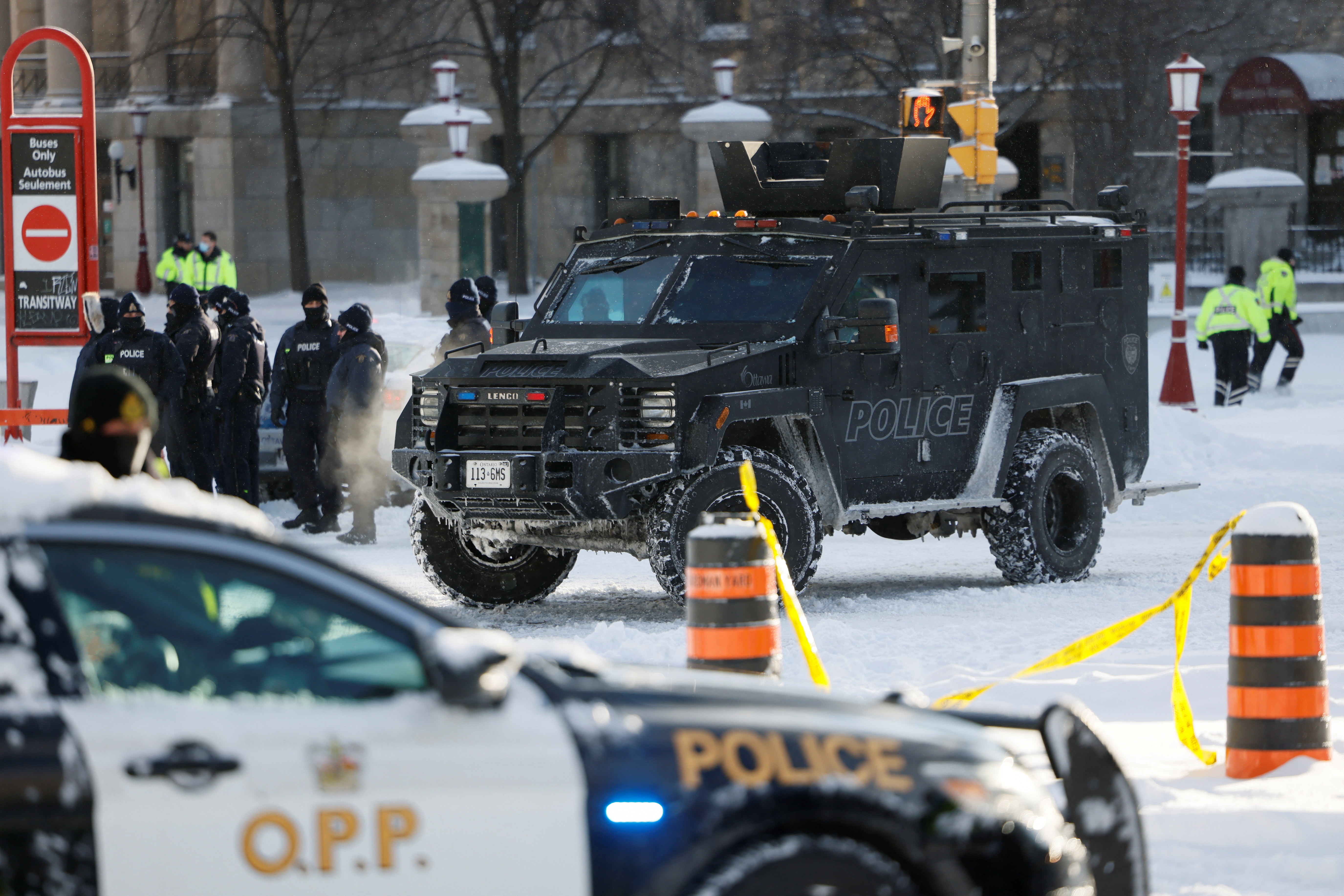 Police officers stand guard, as truckers and supporters continue to protest against the coronavirus disease (COVID-19) vaccine mandates, in Ottawa, Ontario, Canada, February 18, 2022. REUTERS/Blair Gable