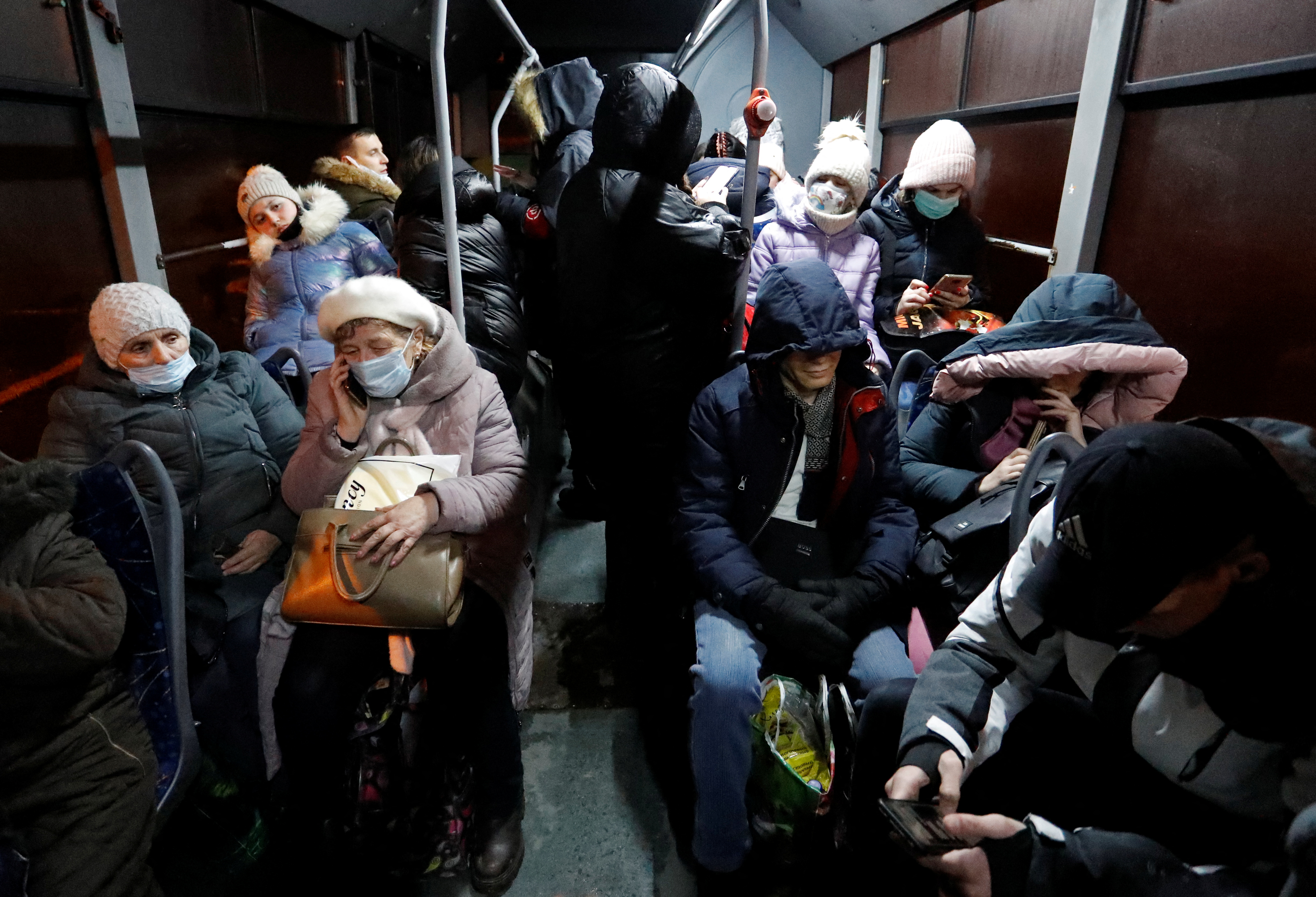 People are seen inside a bus arranged to evacuate local residents, in Donetsk